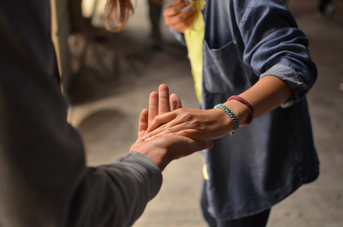 two hands meeting palm to palm