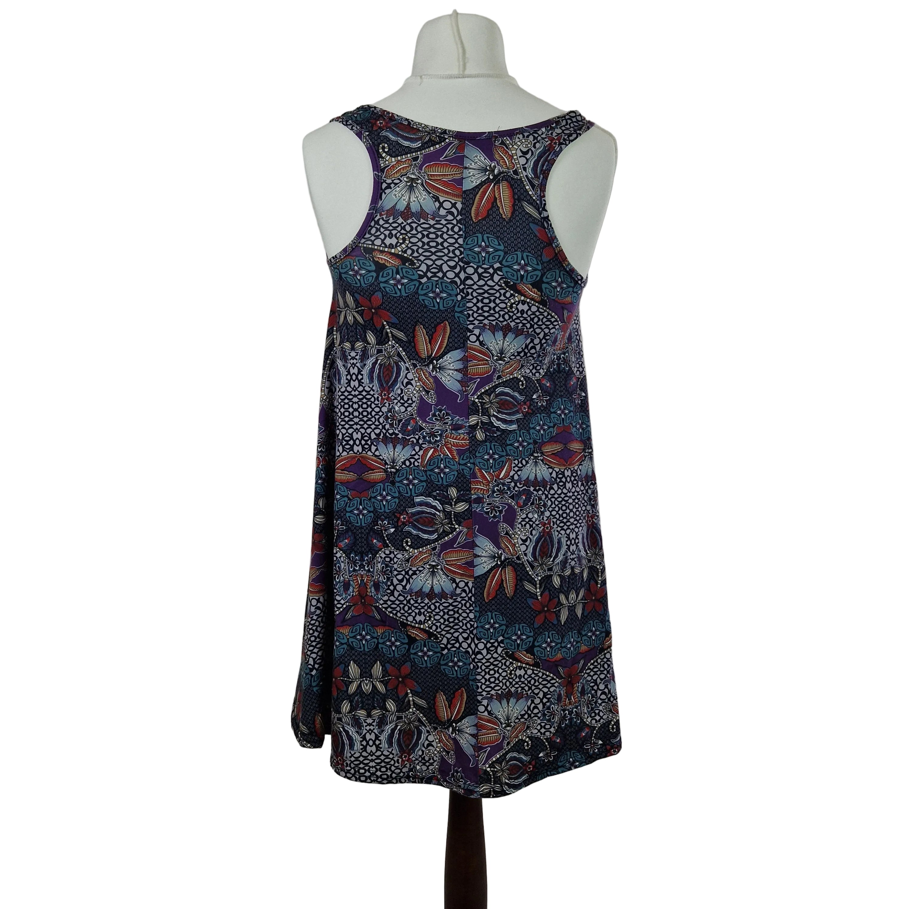 A sleeveless Boohoo beach top in a multicoloured floral and geometric print.