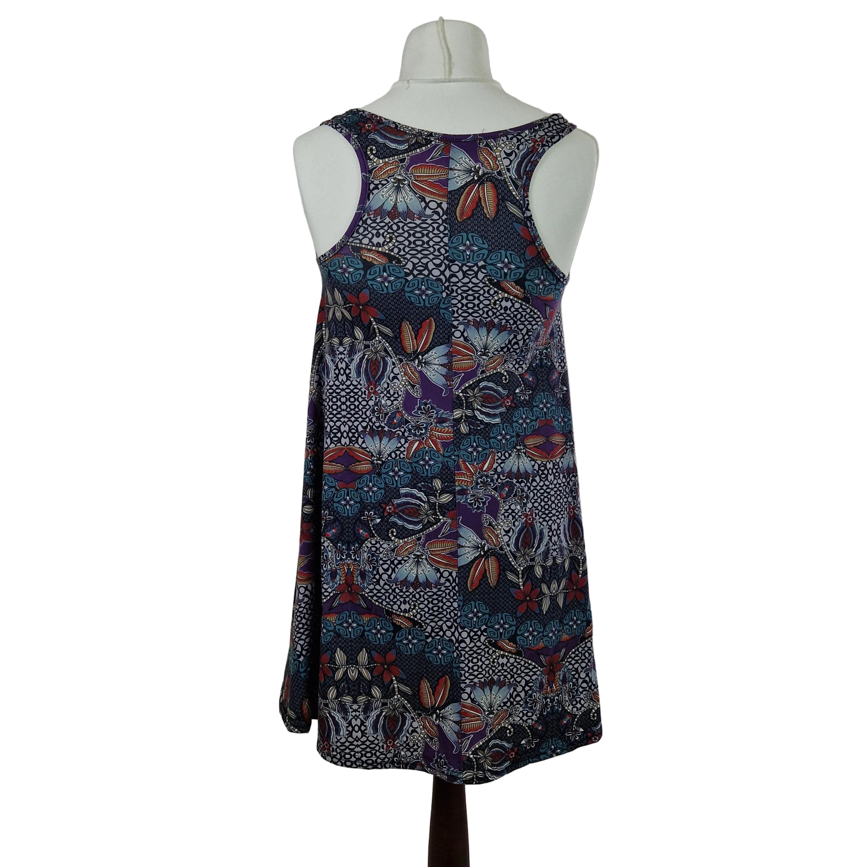 A sleeveless Boohoo beach top in a multicoloured floral and geometric print.