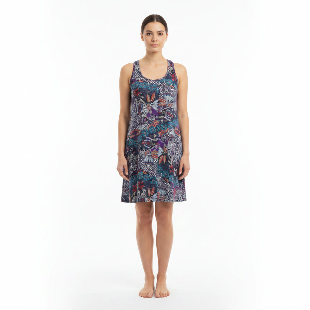 A woman wears a sleeveless, round-neck beach top featuring a multicoloured floral pattern.