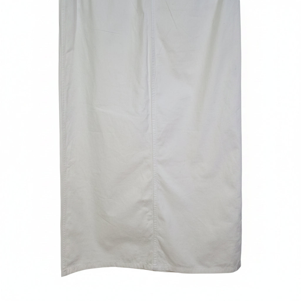 A white Uniqlo A-line midi skirt made from structured cotton twill fabric.
