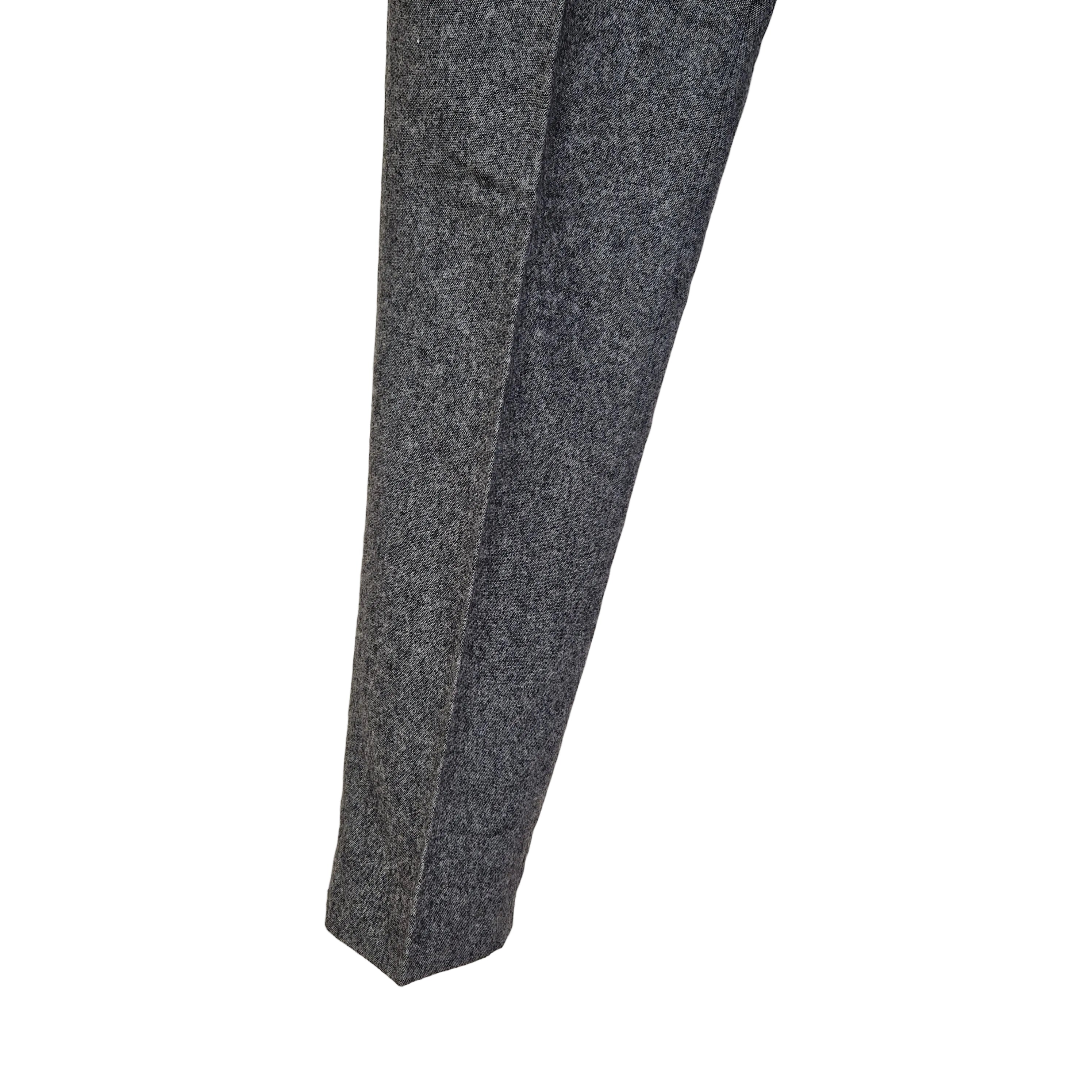 A close-up of the lower leg of grey wool blend formal trousers with a classic straight fit.