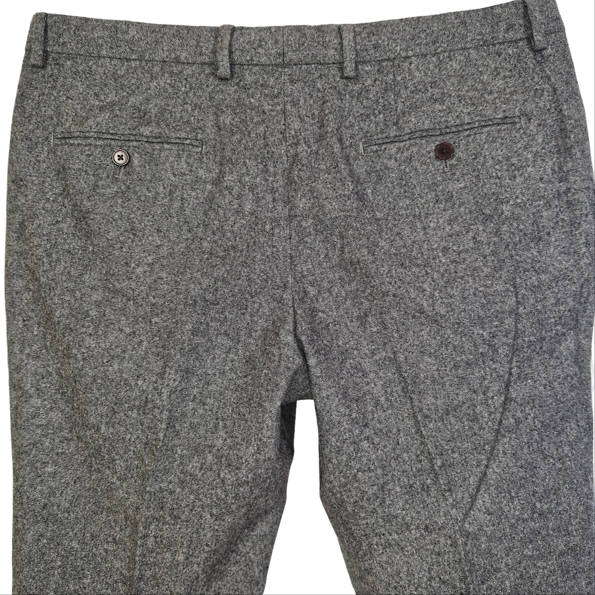 A pair of grey wool blend formal trousers from Next featuring a classic fit and two back pockets.