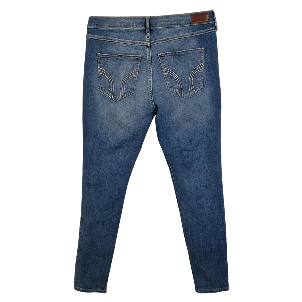A pair of medium blue Hollister high-rise super skinny stretch denim jeans seen from the back.