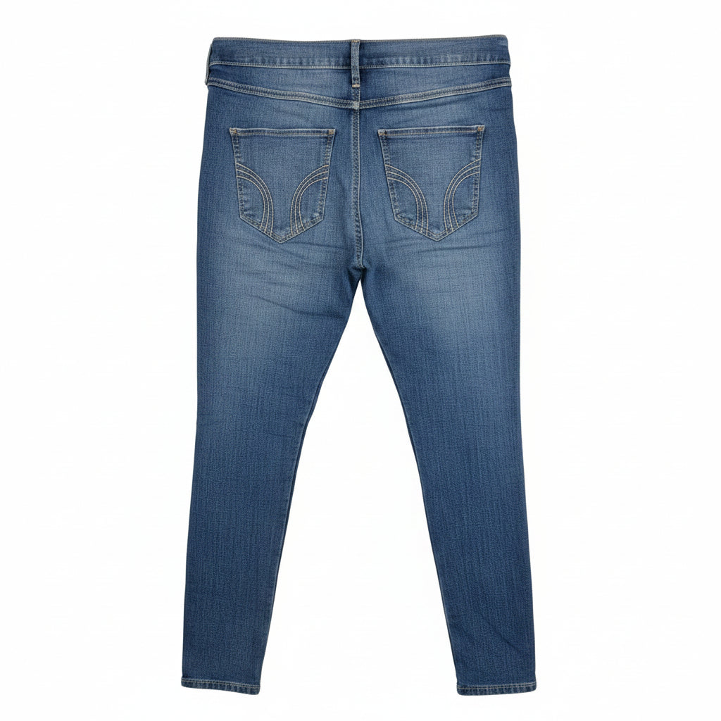 A pair of medium blue Hollister high-rise super skinny stretch denim jeans seen from the back.