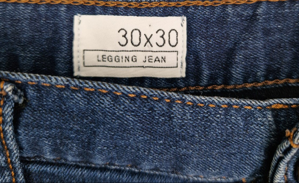 A close-up of a Gap blue denim legging jean label showing a size of 30 by 30.