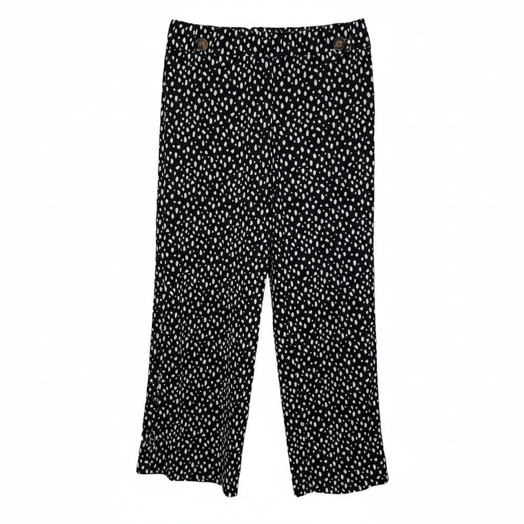 Black tapered trousers in a white speckled print with an elasticated waist and button hem details.
