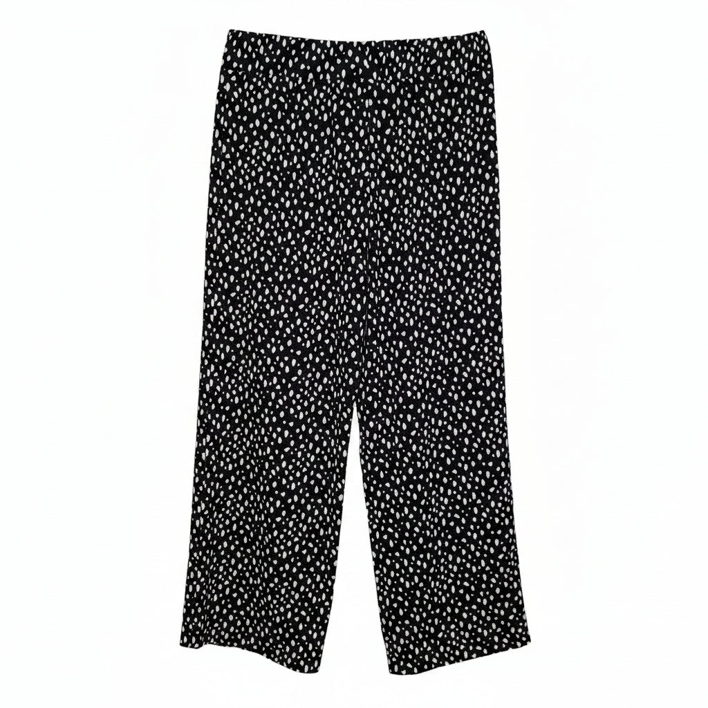 Black tapered trousers in a lightweight crepe fabric featuring an all-over white dot print.