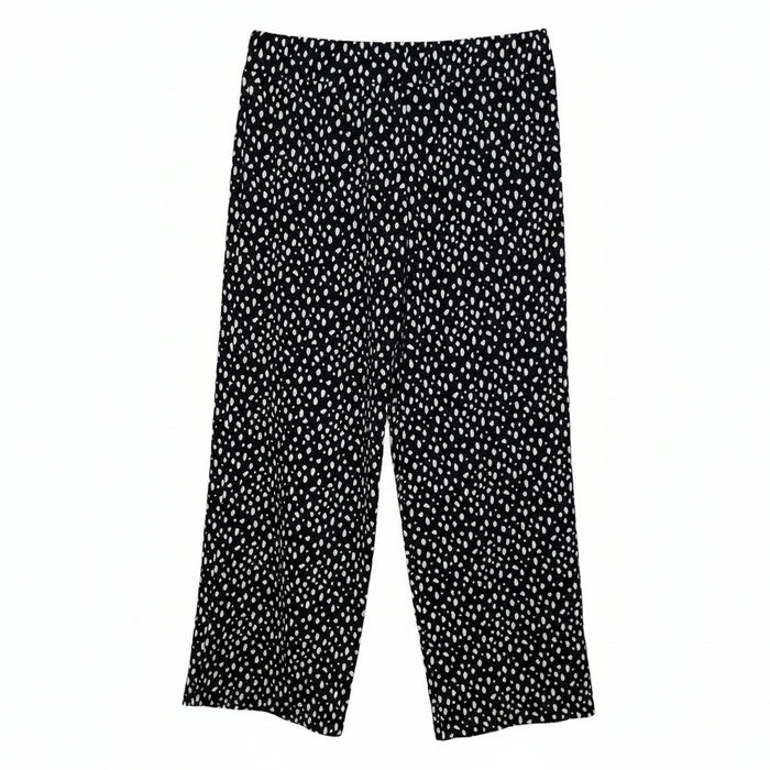 Black tapered trousers featuring a white speckled pattern and an elasticated waistband.
