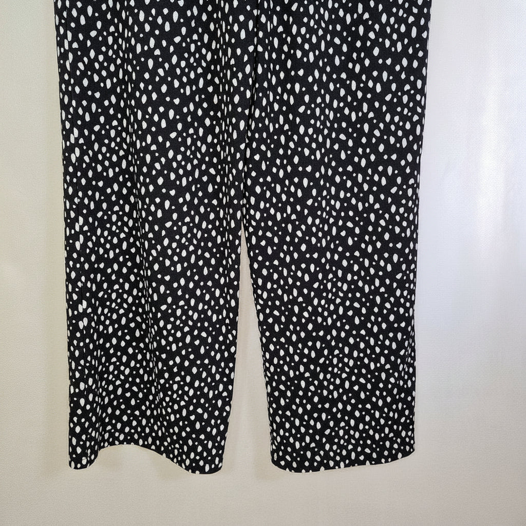 Black tapered trousers featuring a white speckled pattern and a pull-on elasticated waist.