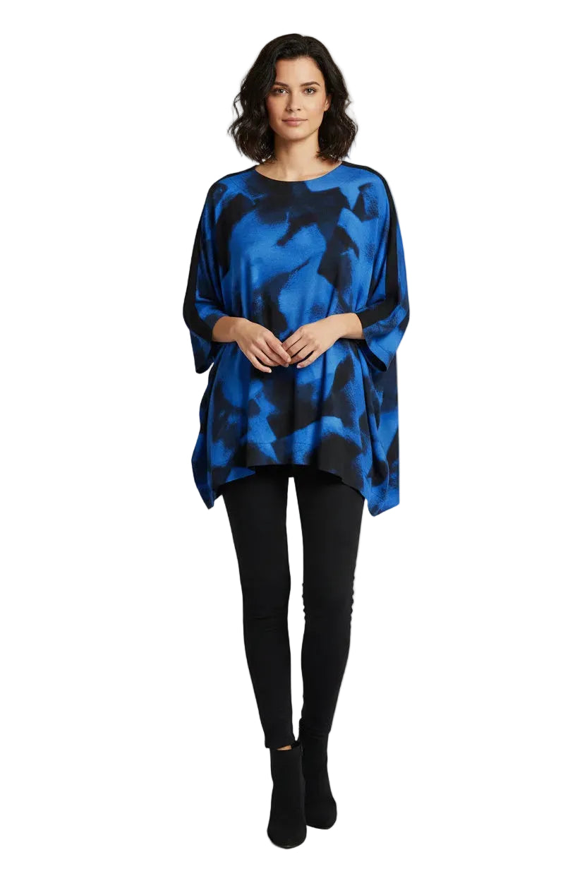 A woman wears a blue and black abstract print tunic with a round neck and short sleeves.