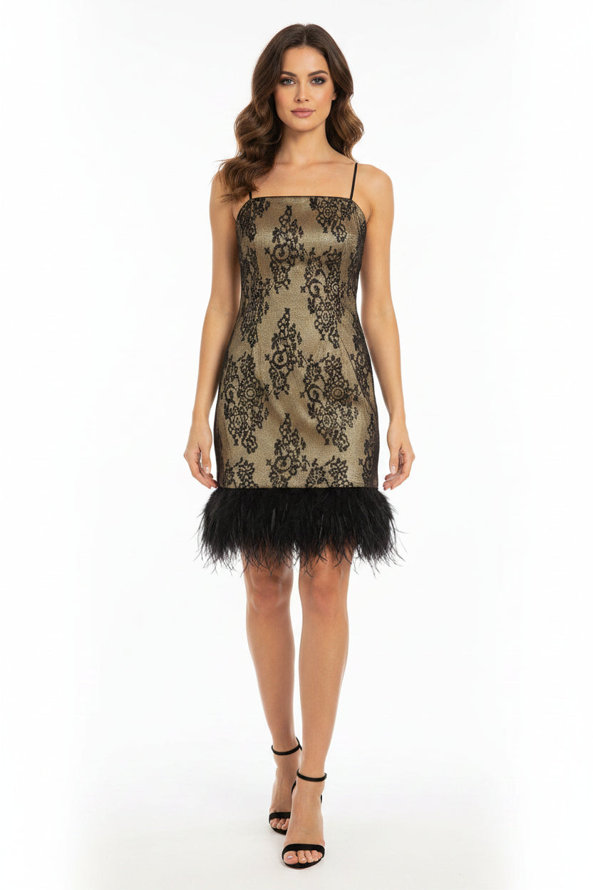 Decorative dress with black lace pattern and feather details on a plain background