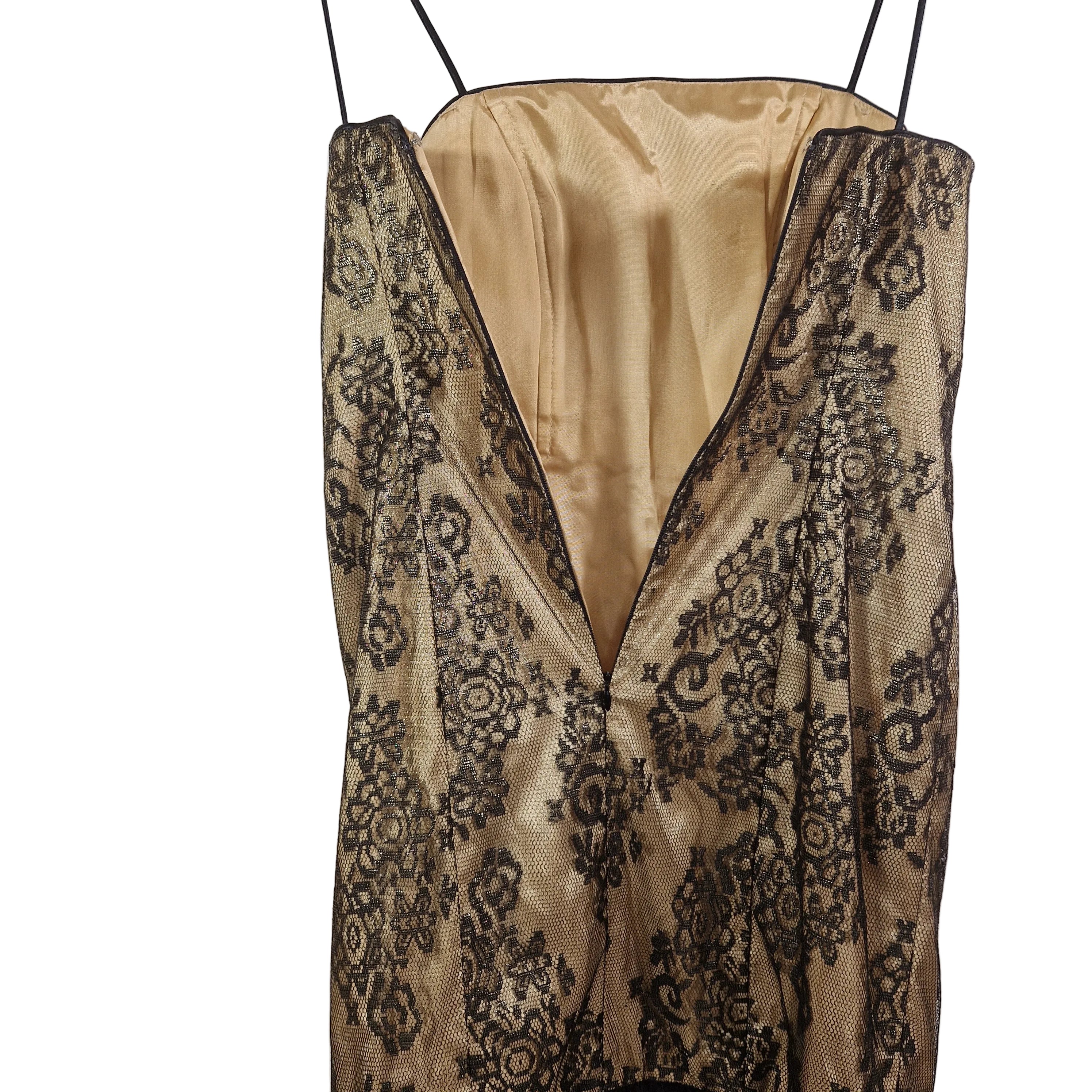 Beige slip dress with black lace detailing on a white background