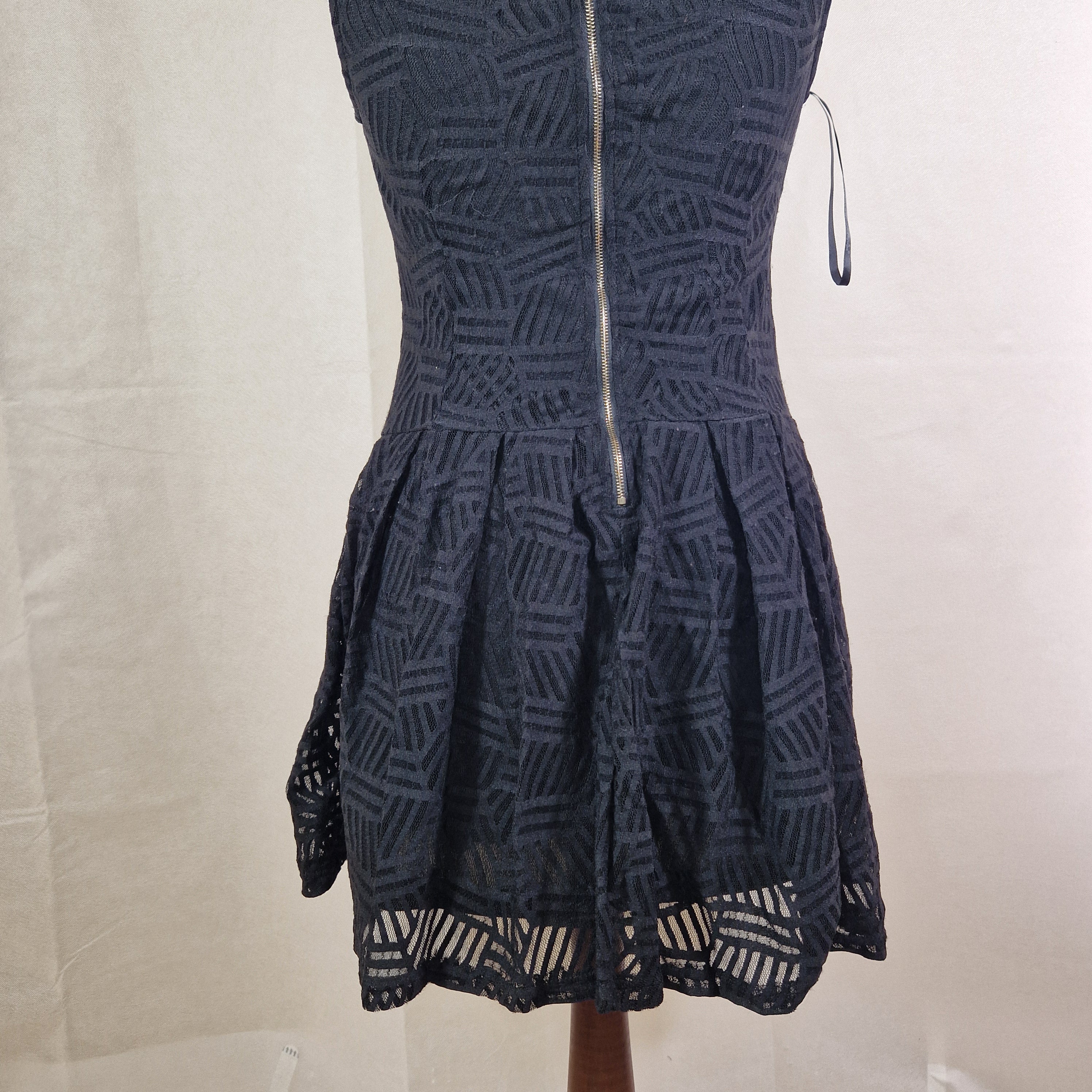 Black strapless dress with geometric pattern on a white surface