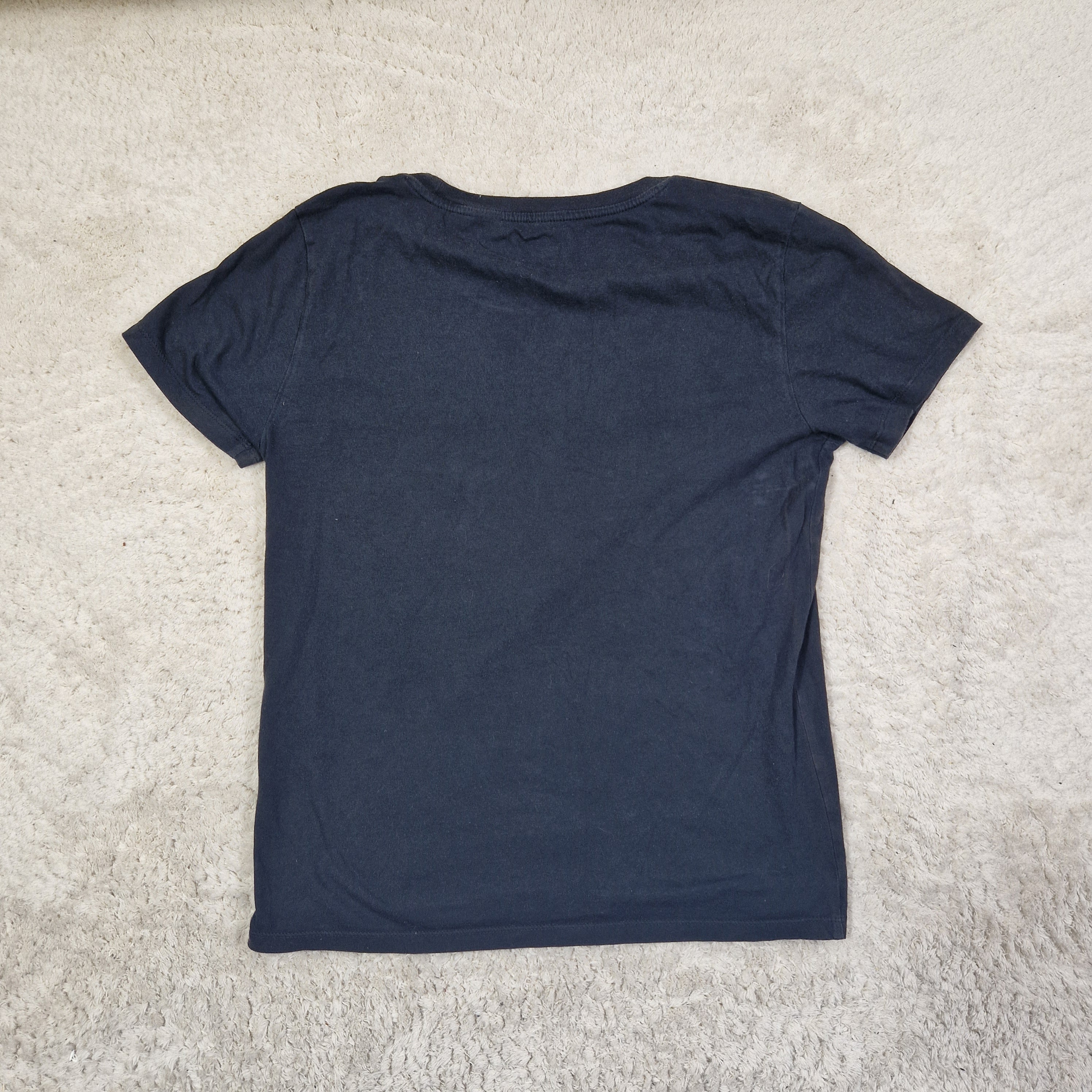 Blue sleeveless top on a beige carpet