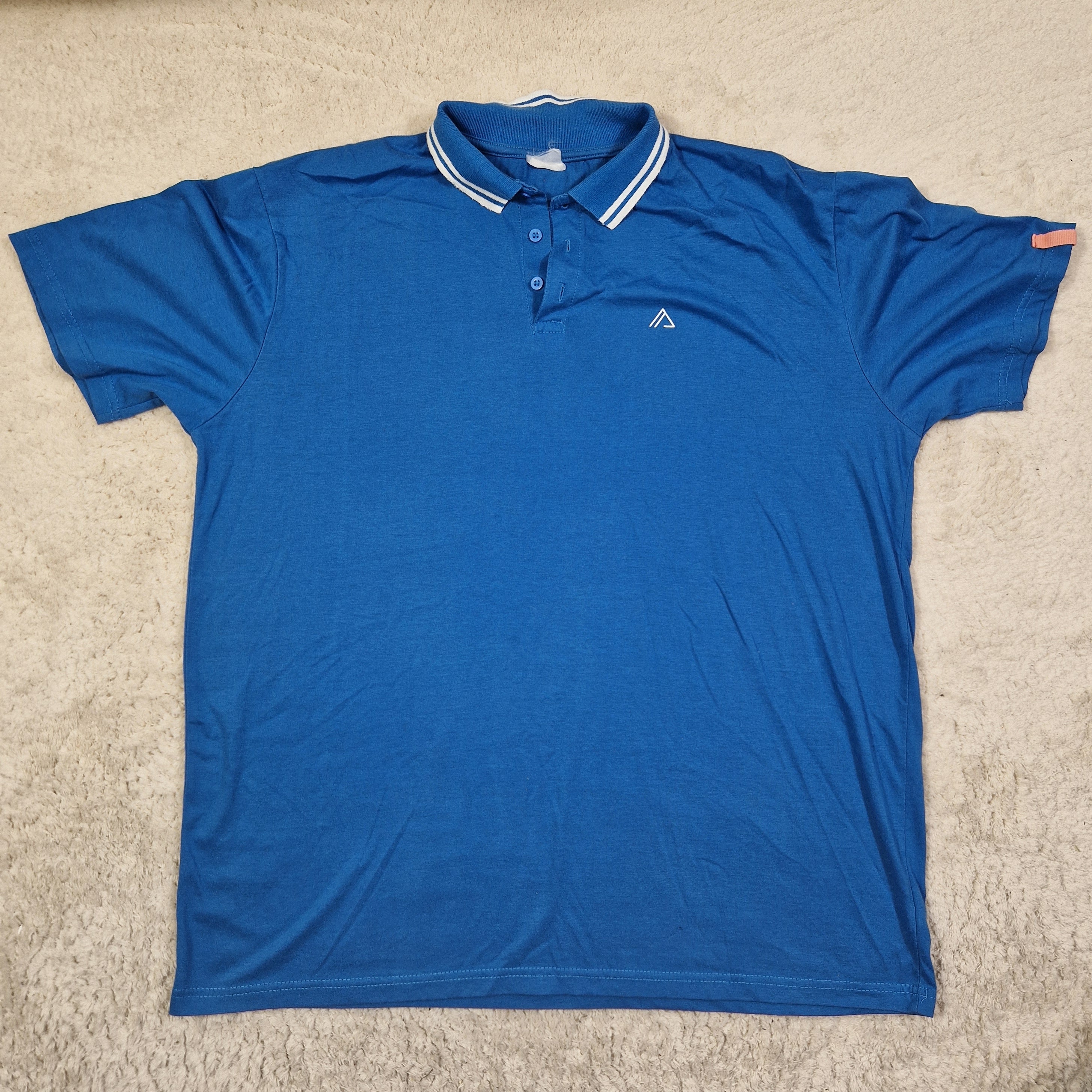 Blue polo shirt on a beige carpet