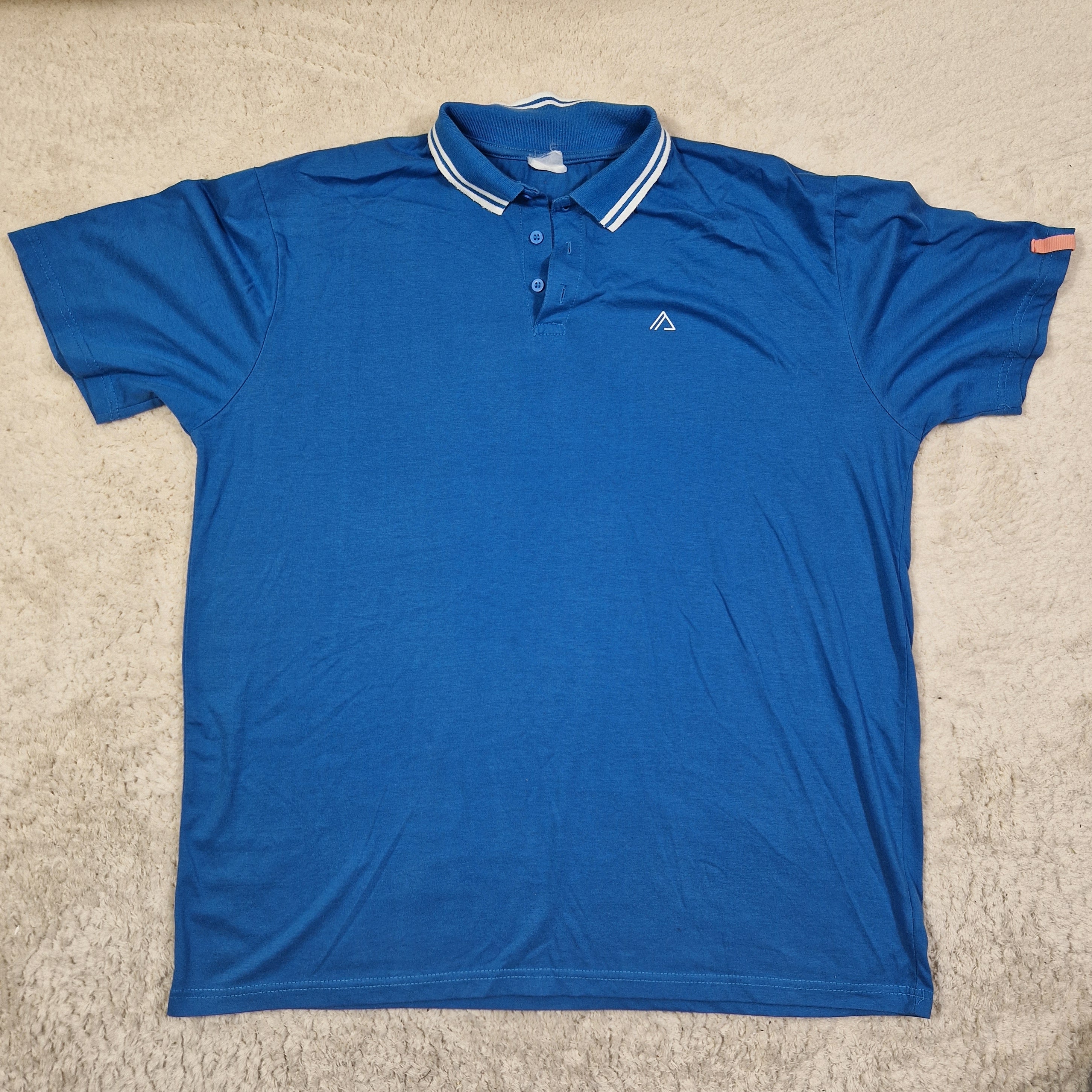 Blue polo shirt on a beige carpet