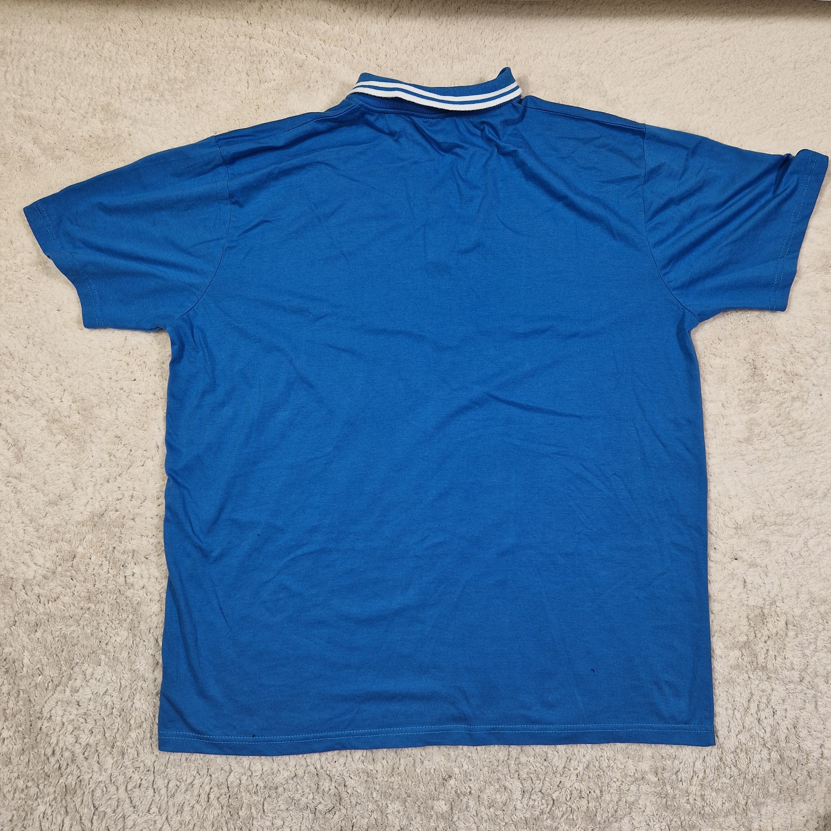 Blue sleeveless shirt on a beige carpet