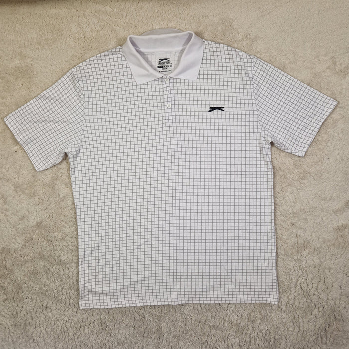 White checkered shirt with a logo on a beige surface