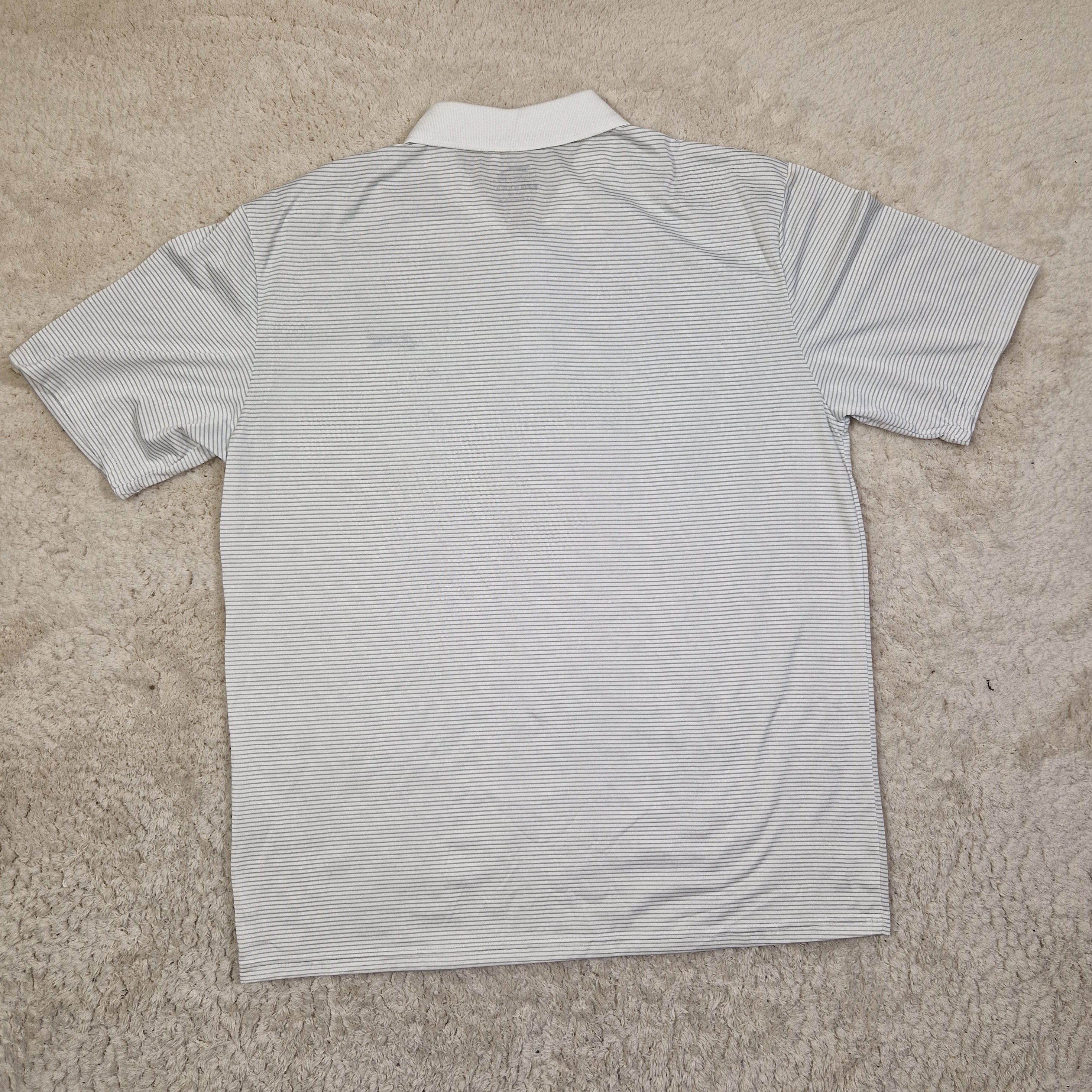 White shirt with blue stripes on a beige carpet