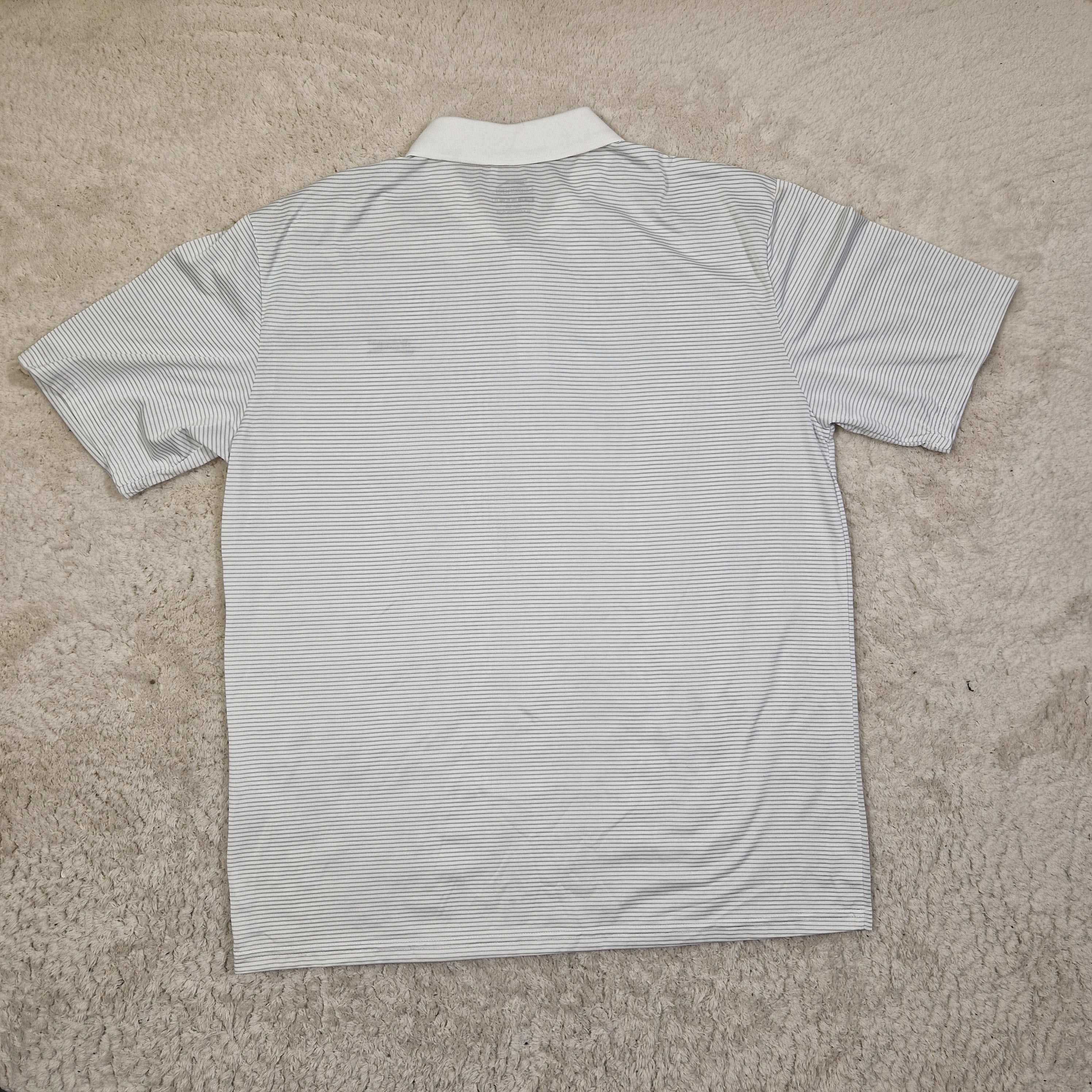 Light blue striped shirt on a beige carpet