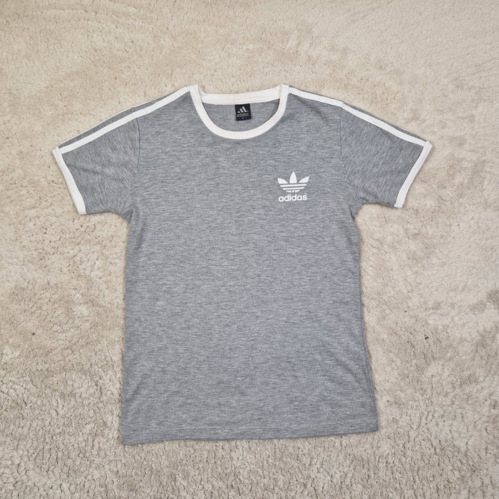 Gray t-shirt with Adidas logo on a beige carpet