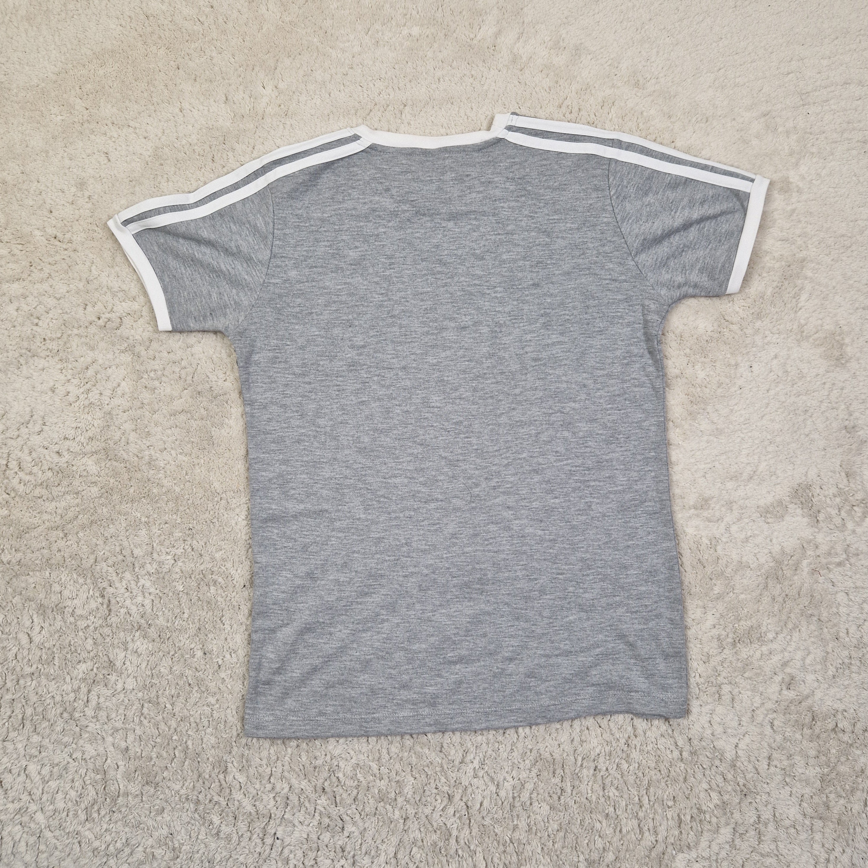 Gray shorts with white trim on a beige carpet