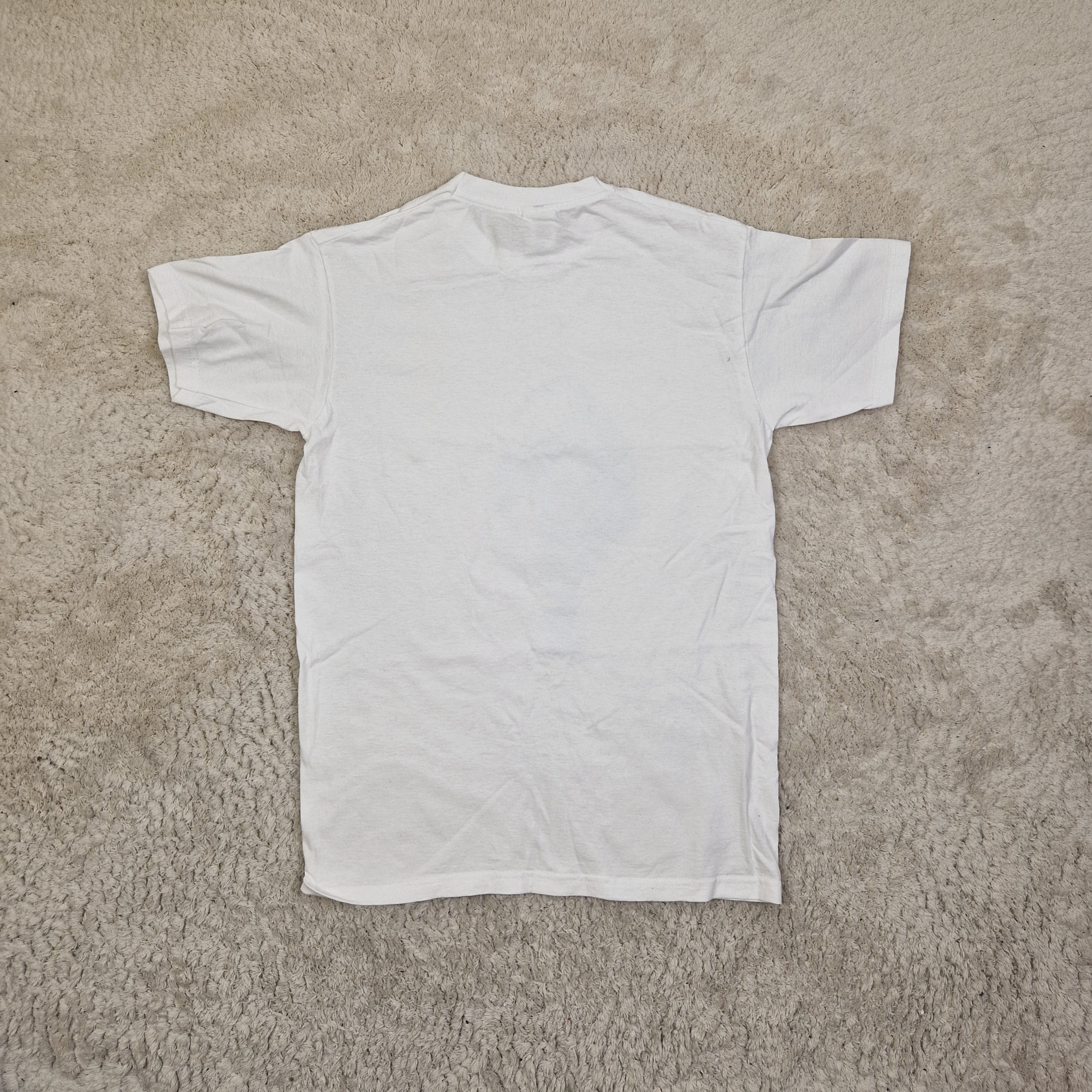White t-shirt on a beige carpet