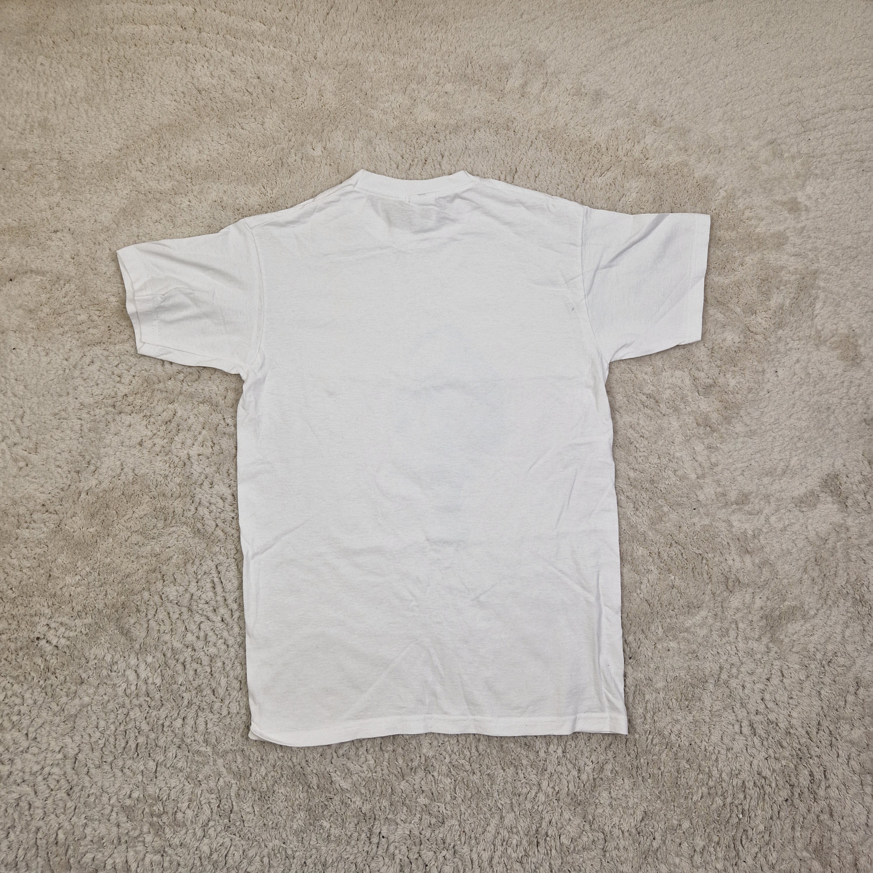 White t-shirt on a beige carpet