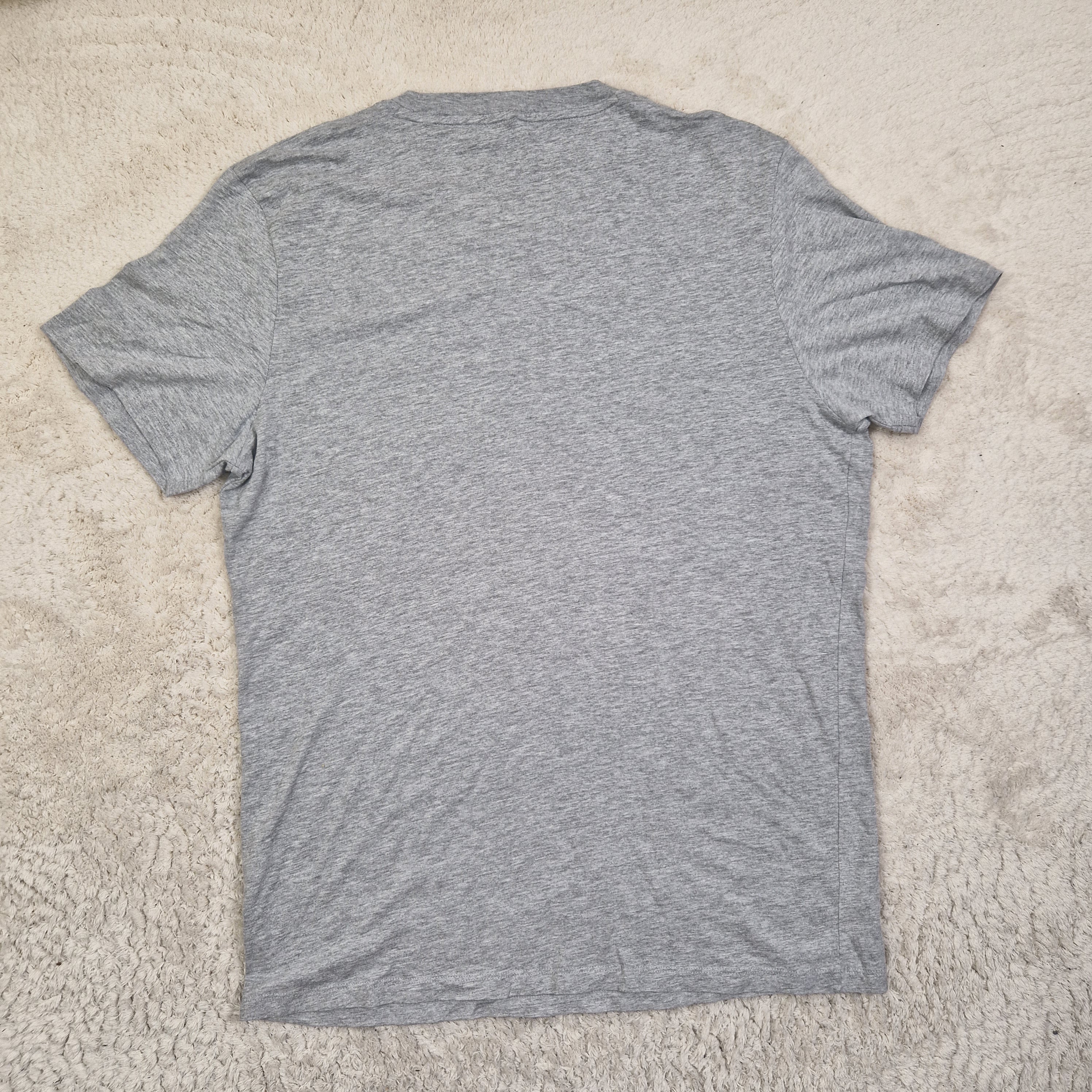 Gray t-shirt on a beige carpet