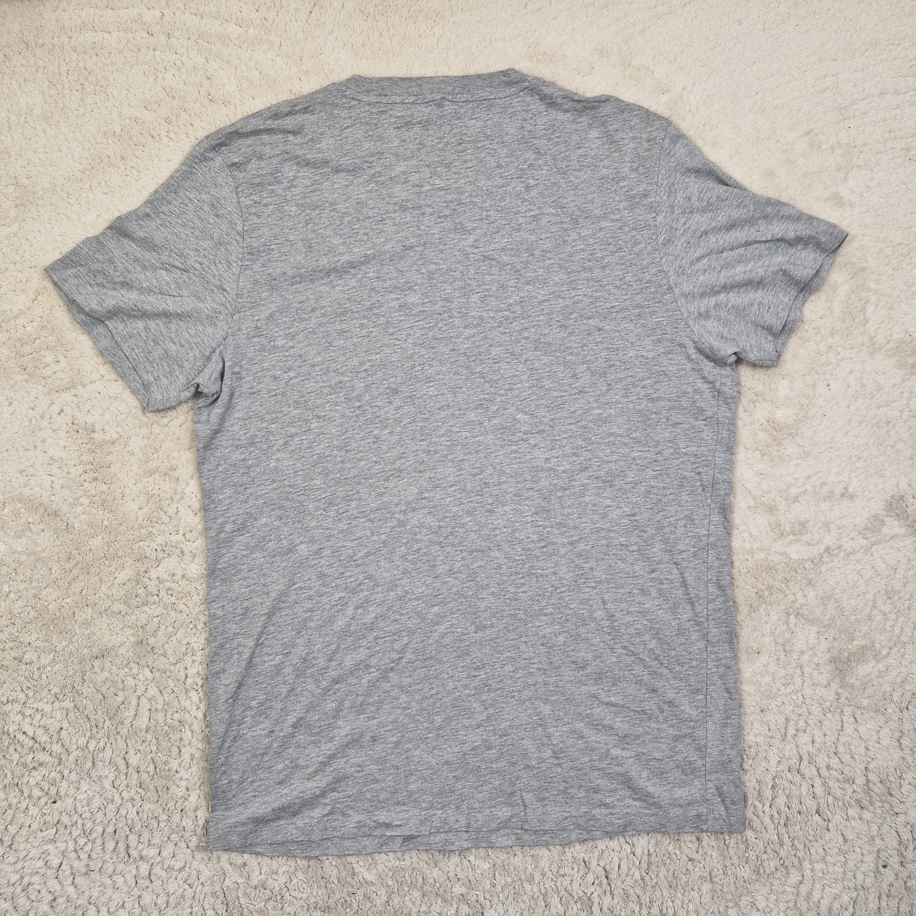 Gray t-shirt on a beige carpet