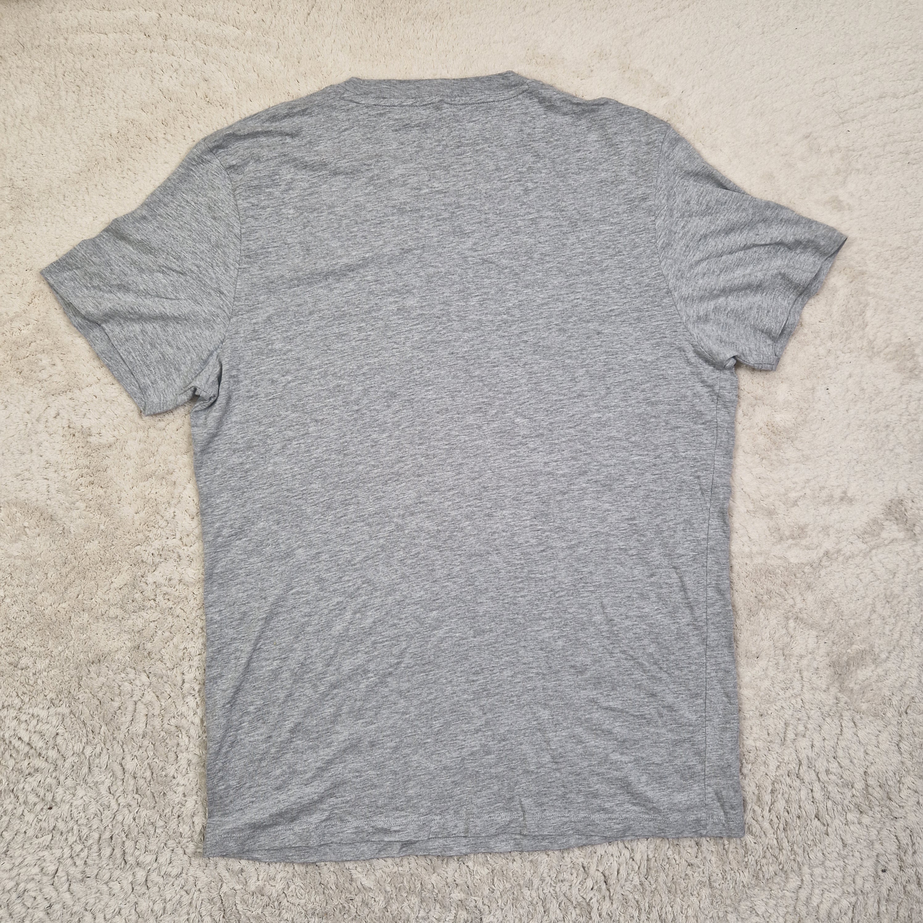 Gray t-shirt on a beige carpet