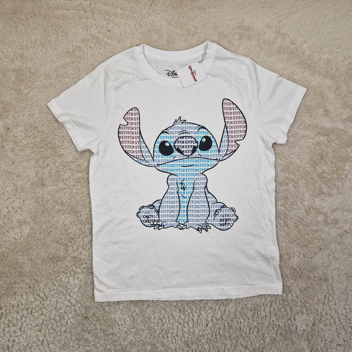 White t-shirt with a dog graphic on a beige carpet