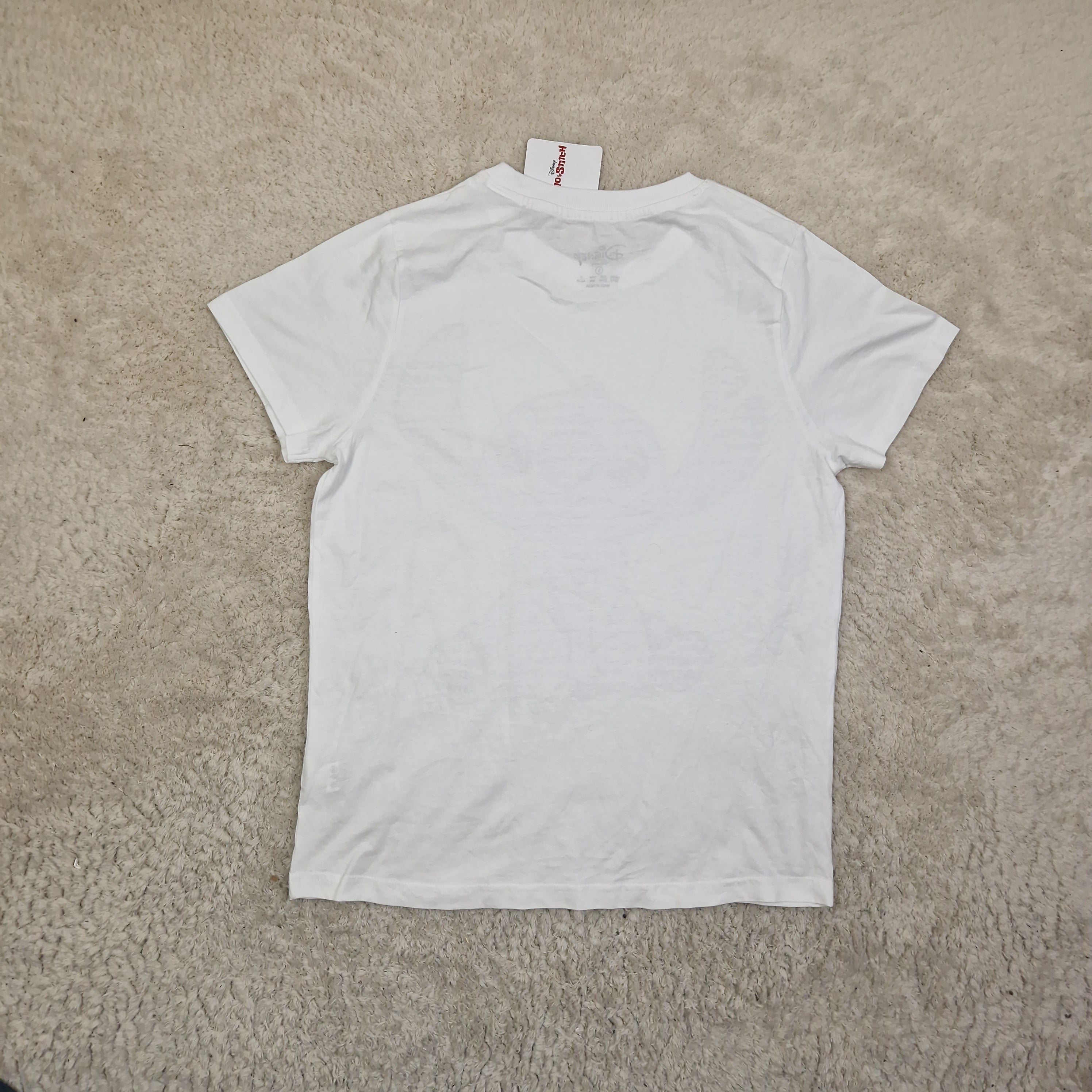 White t-shirt on a beige carpet