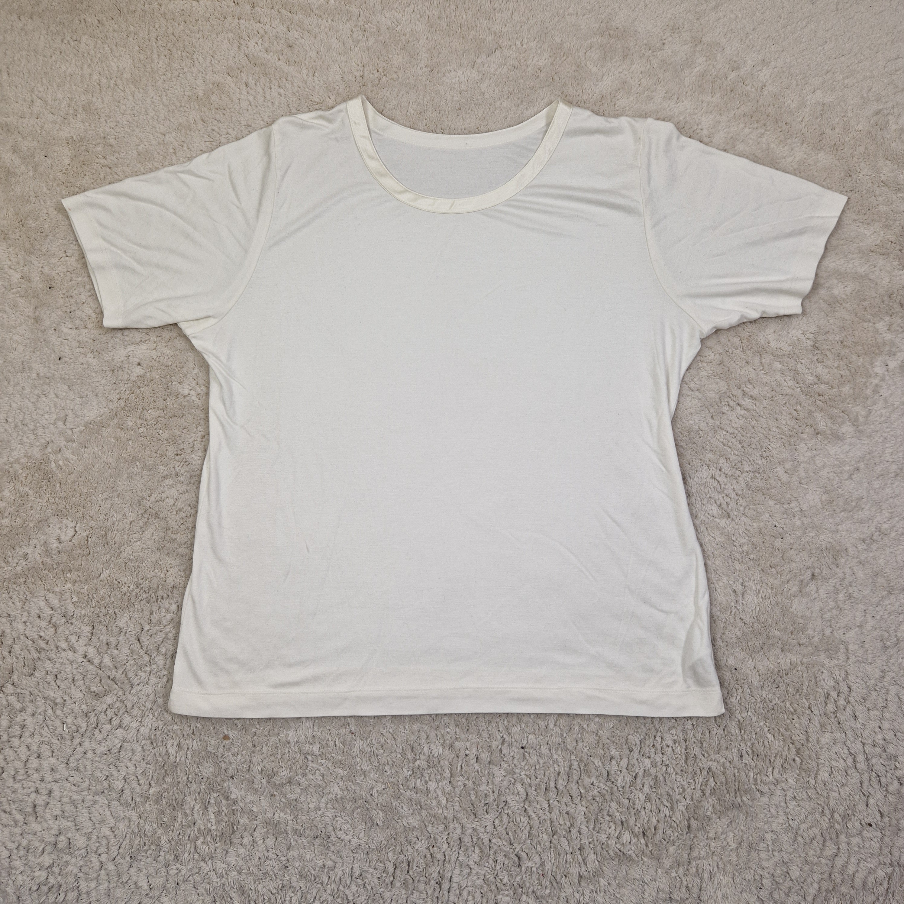 White tank top on a beige carpet