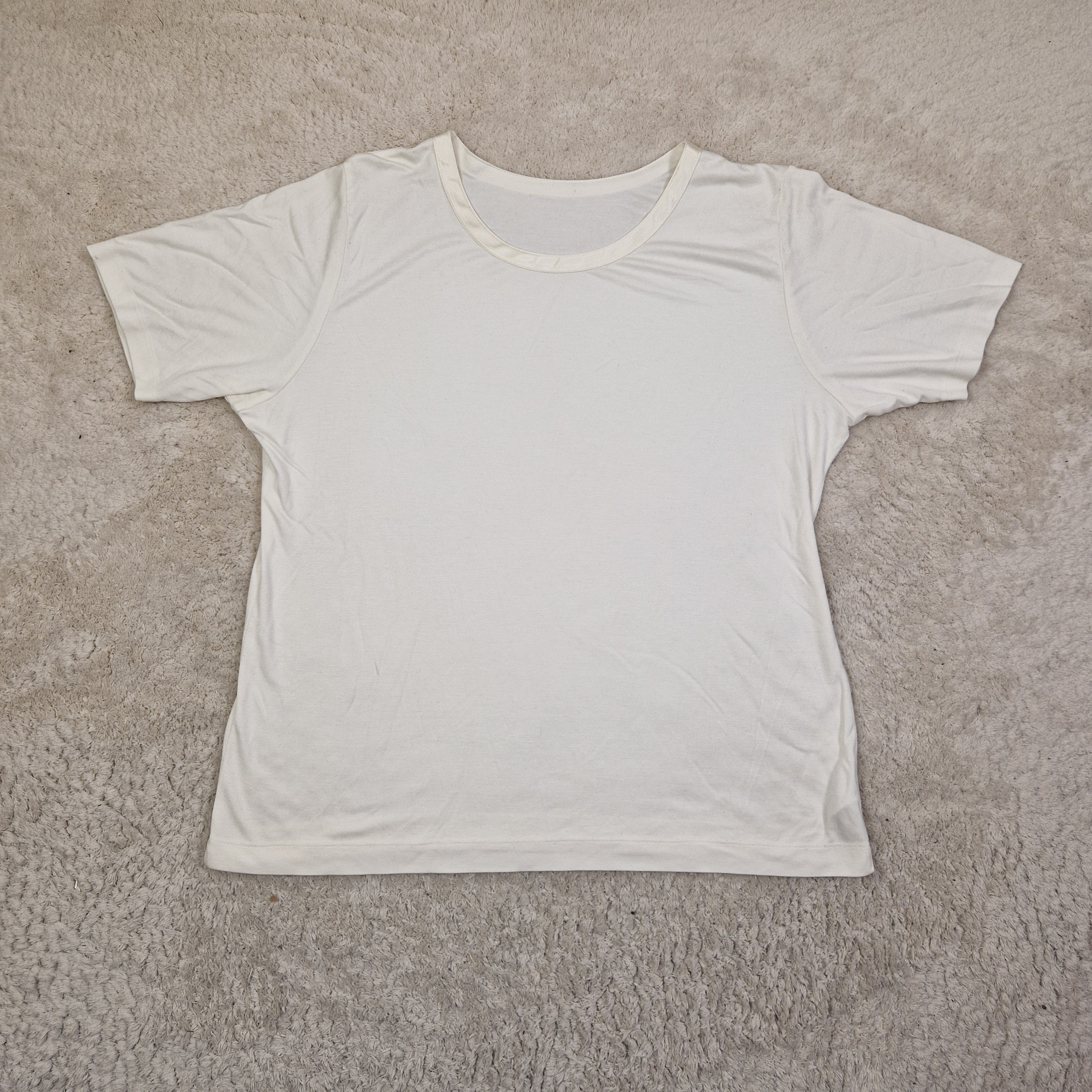 White tank top on a beige carpet