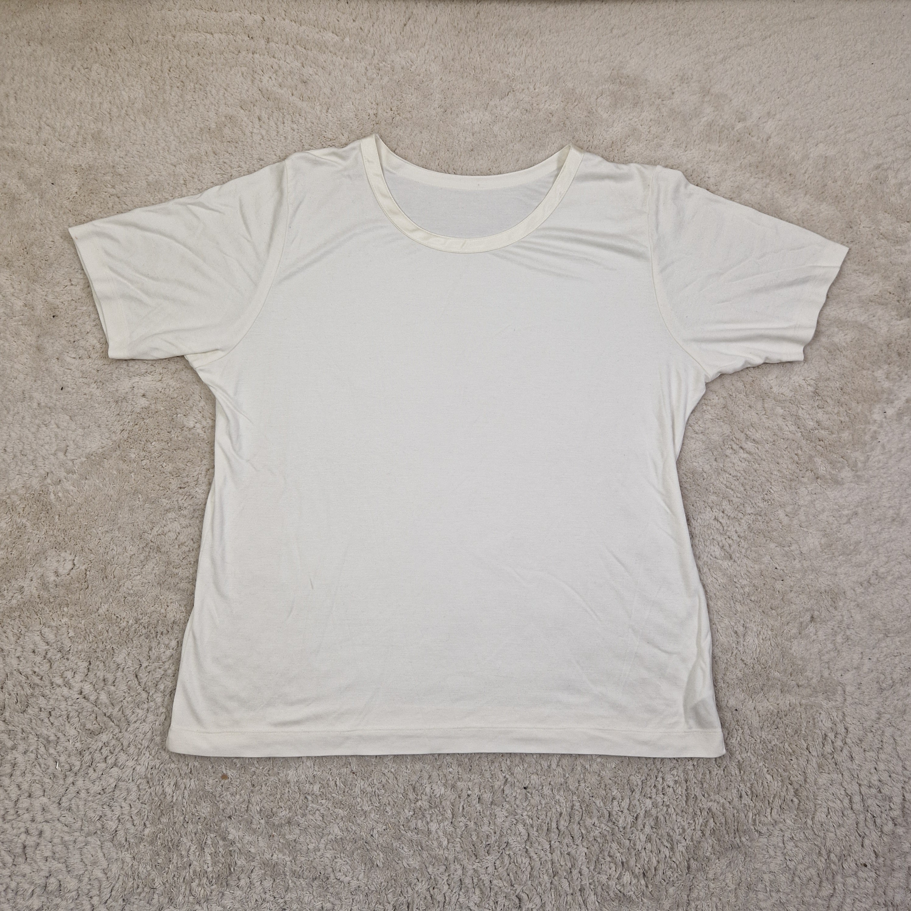 White tank top on a beige carpet