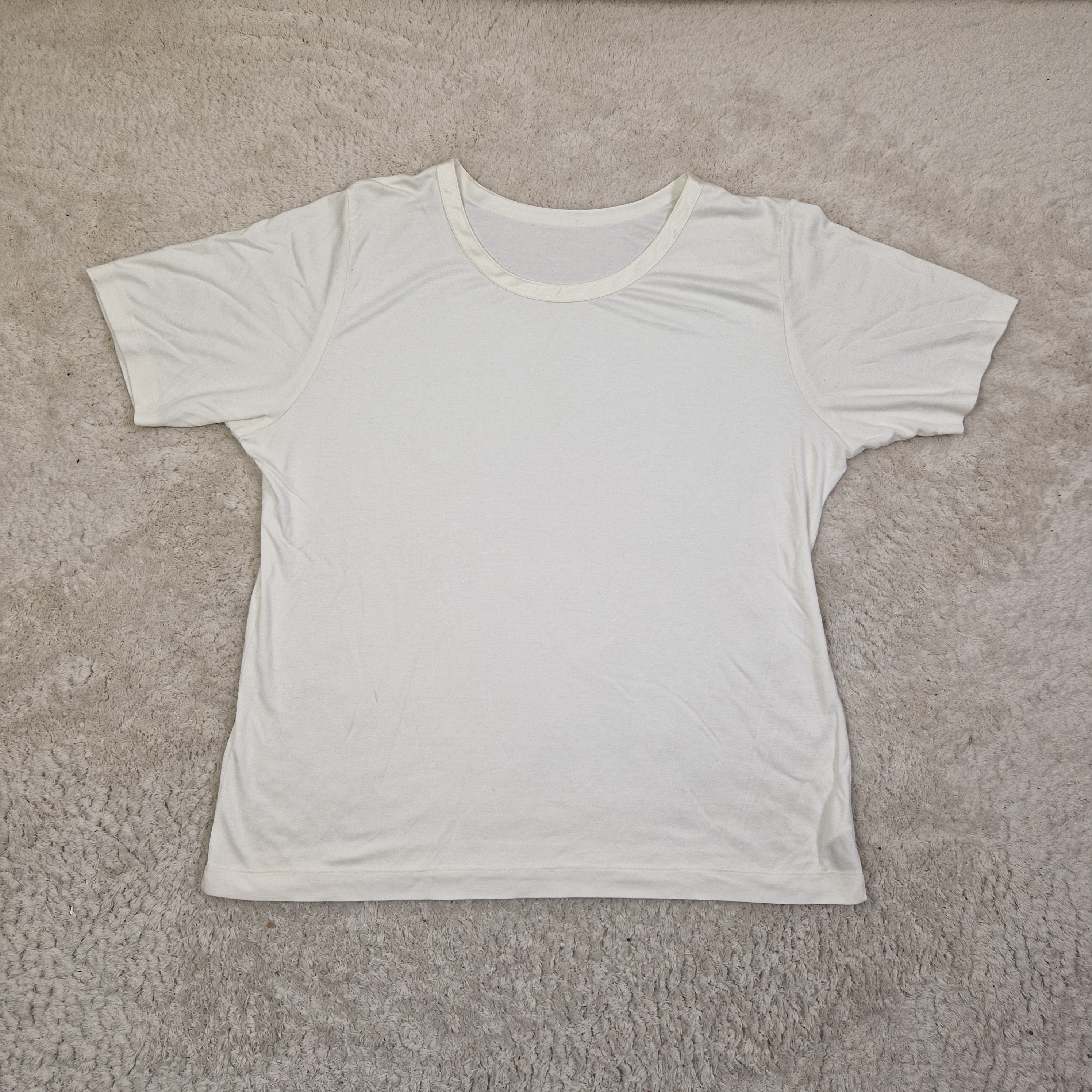 White tank top on a beige carpet