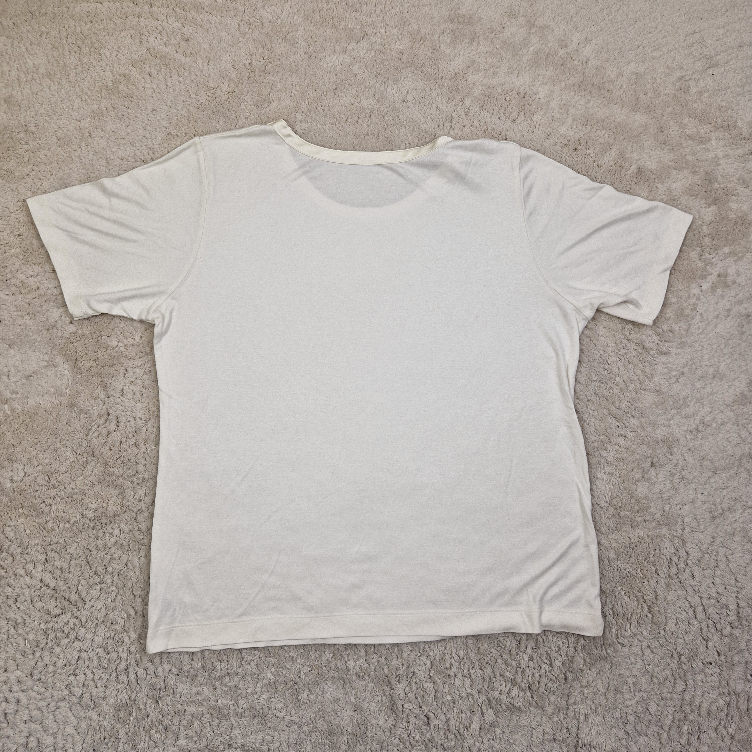White tank top on a beige carpet