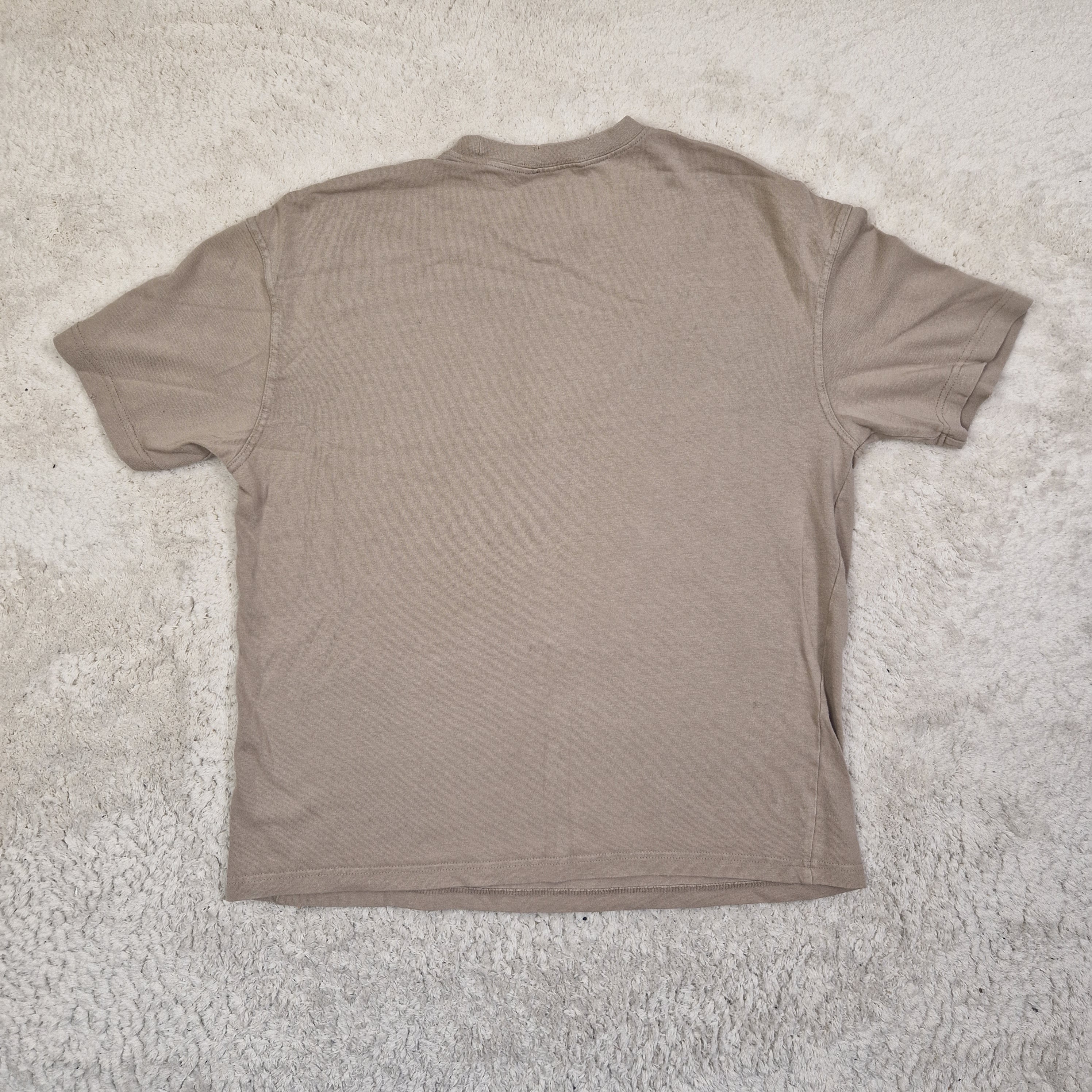 Brown t-shirt on a textured beige surface