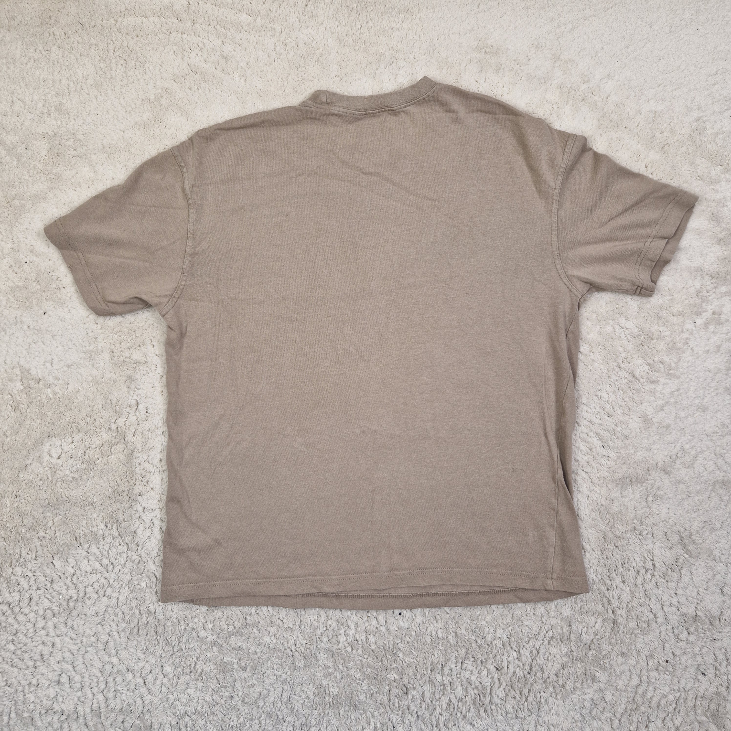 Brown t-shirt on a textured gray surface