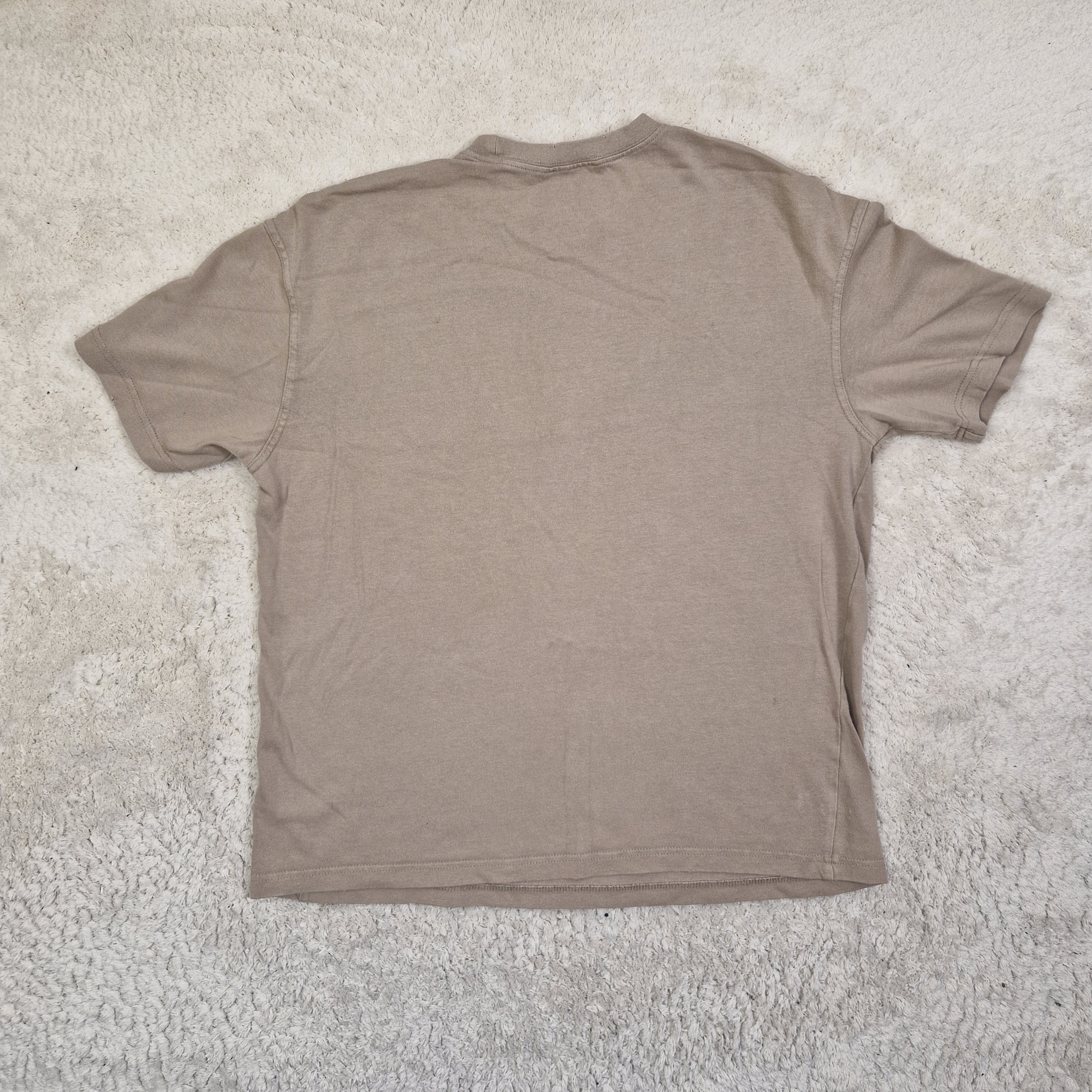 Brown t-shirt on a textured beige surface