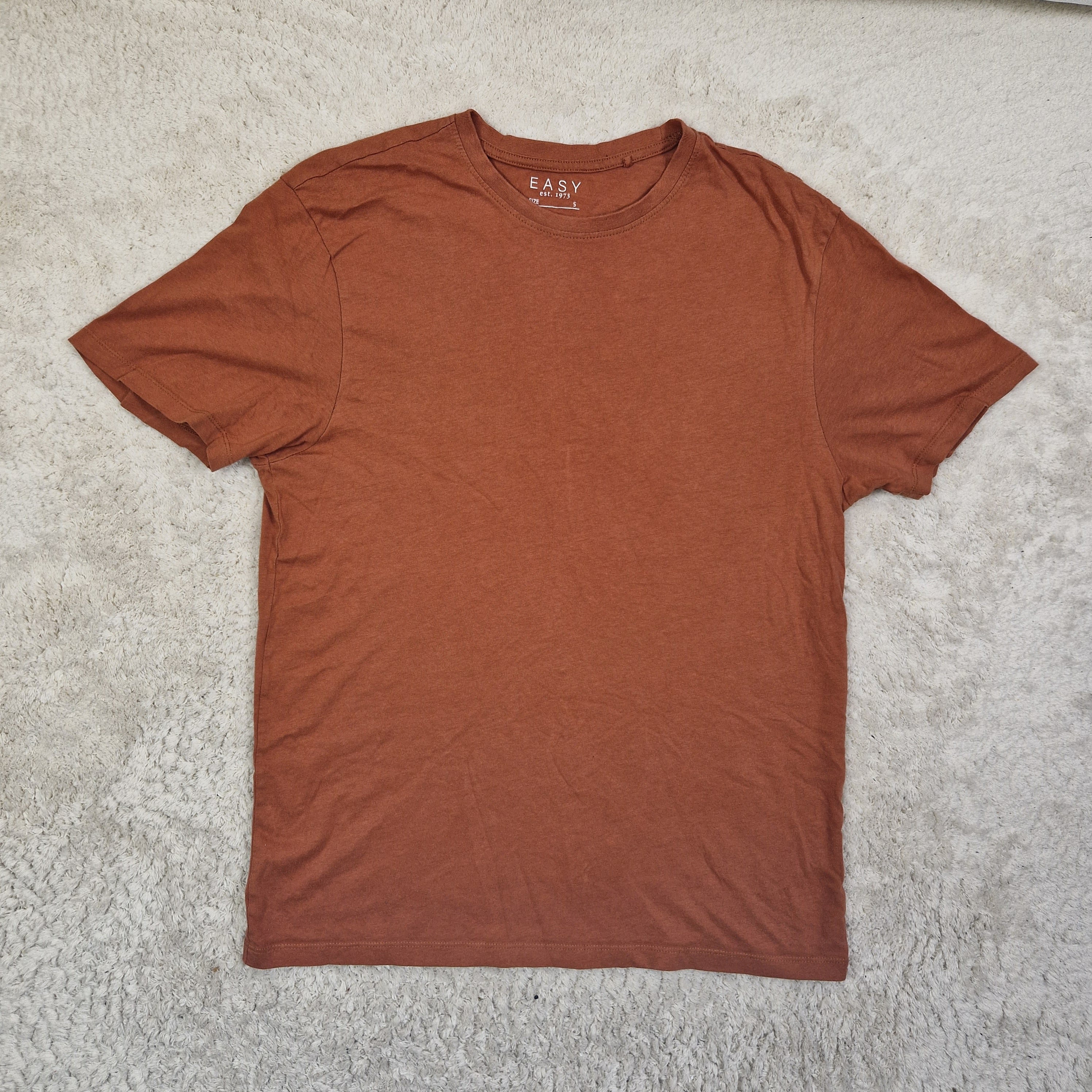 Brown t-shirt on a textured surface