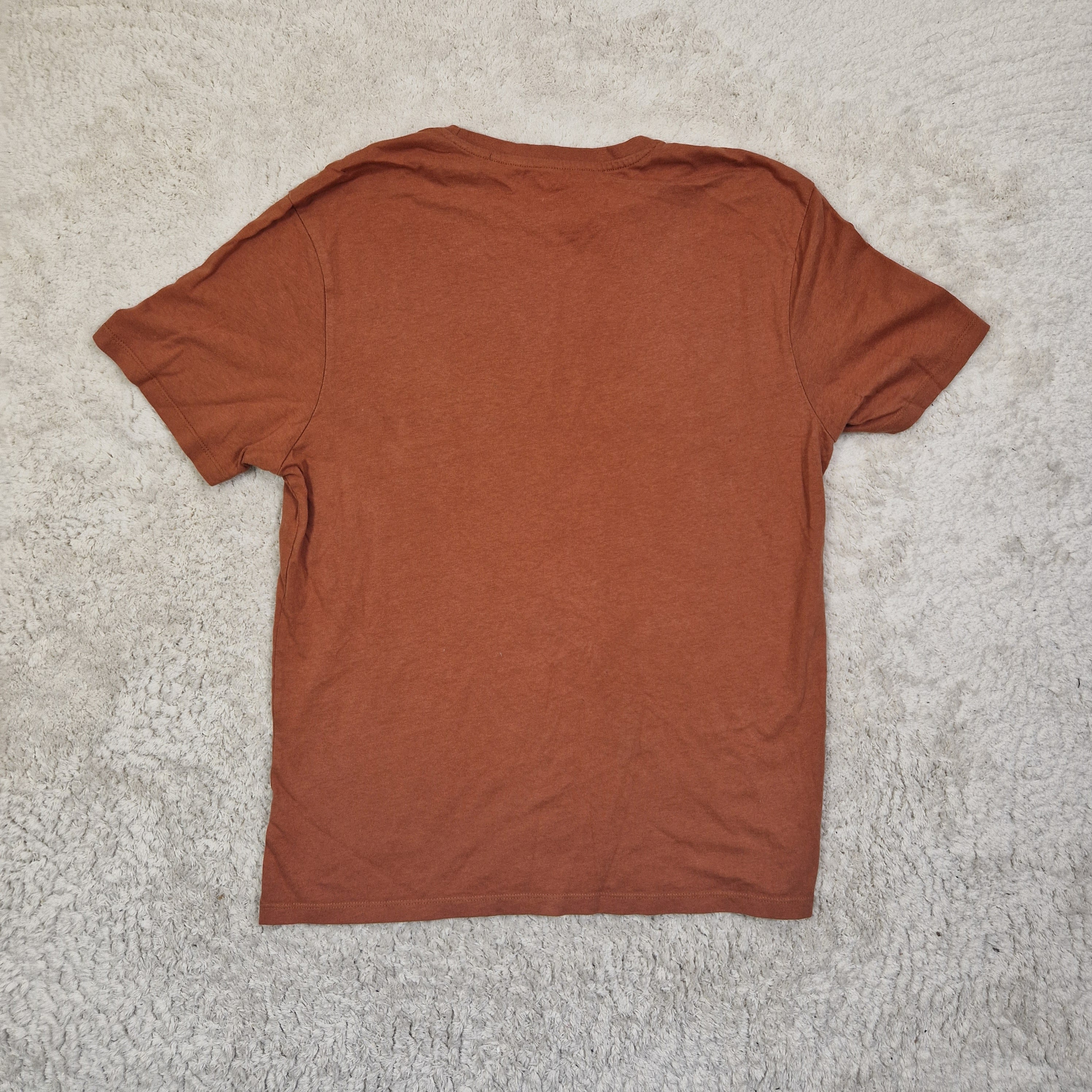 Brown t-shirt on a beige carpet
