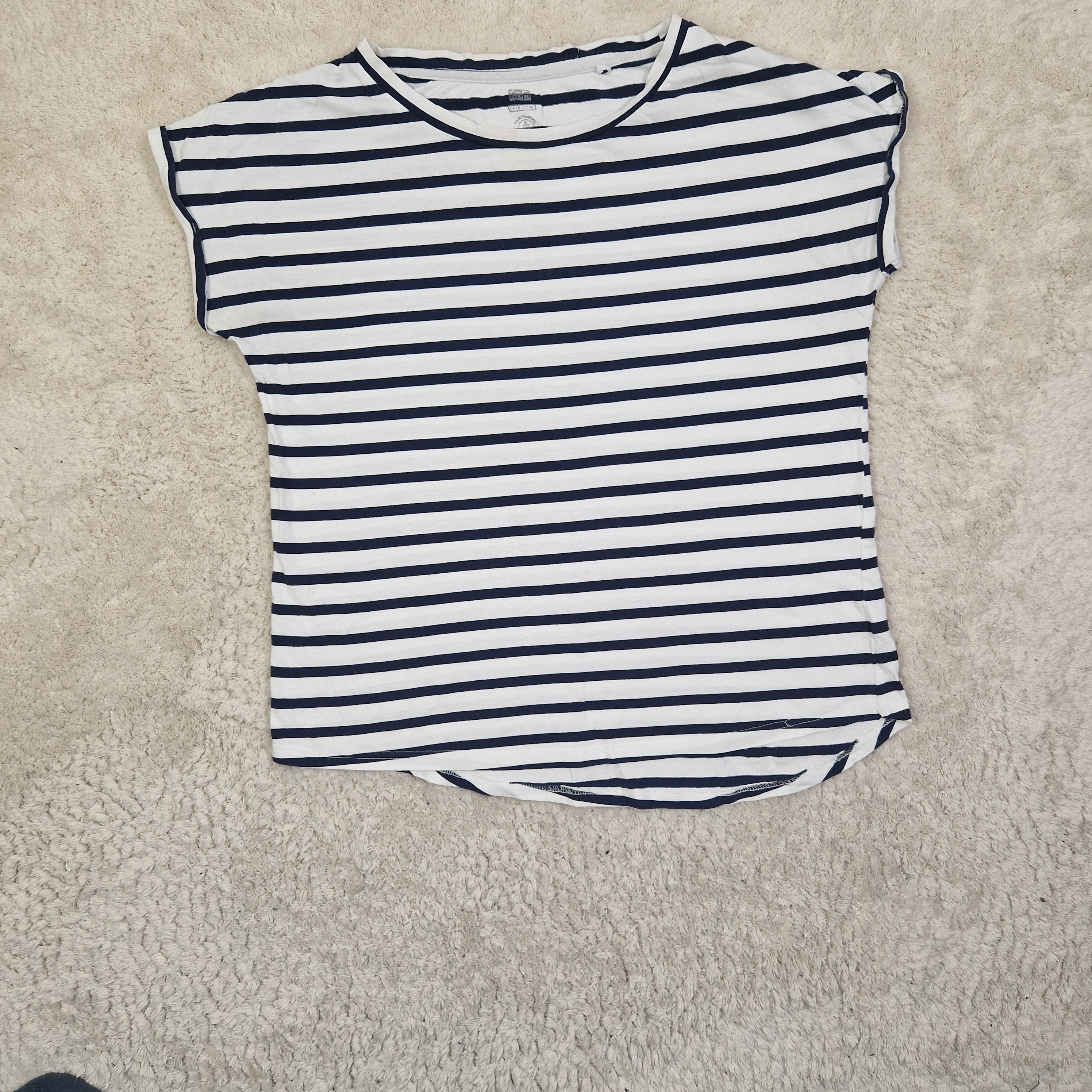Striped shirt on a beige carpet