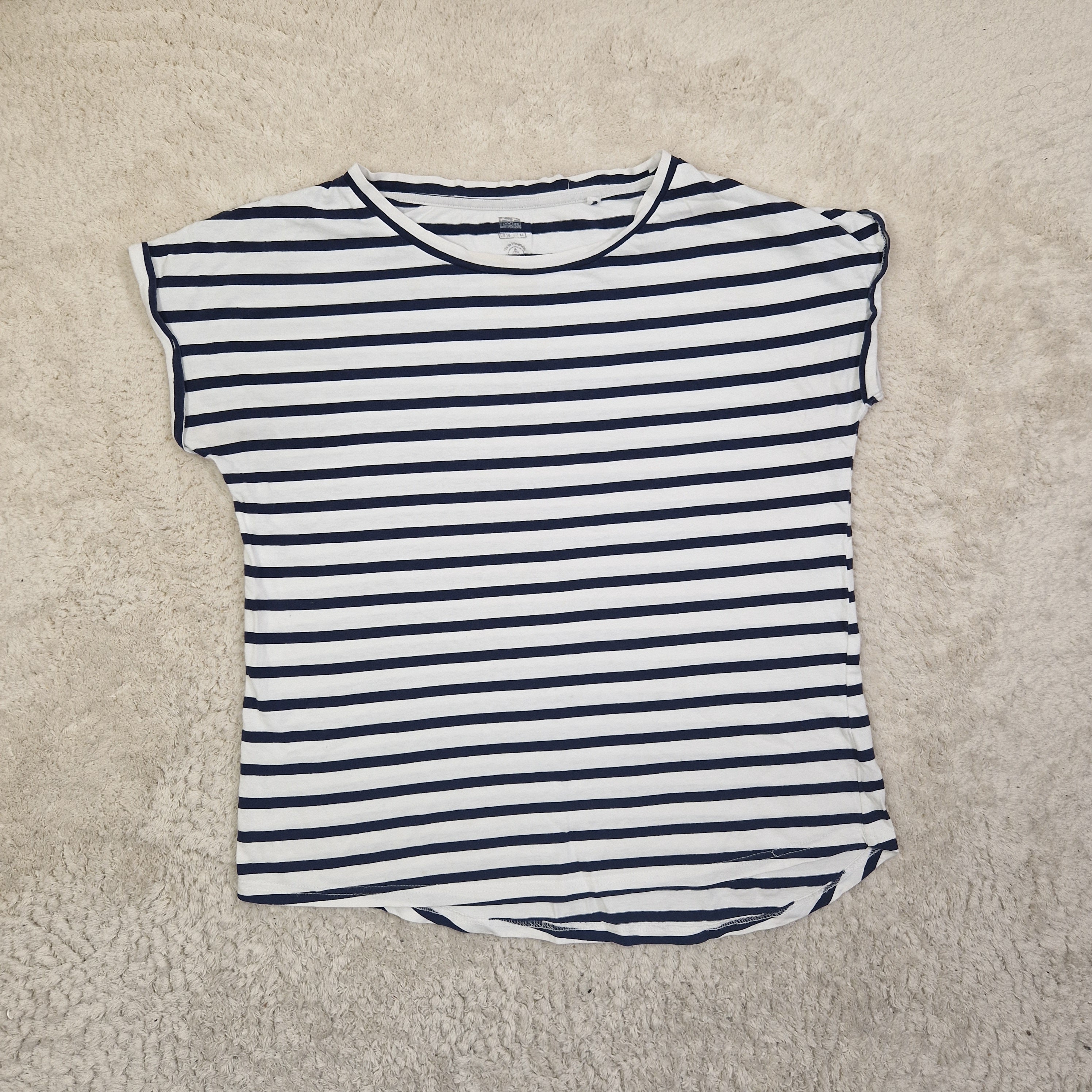 Black and white striped shirt on a beige carpet