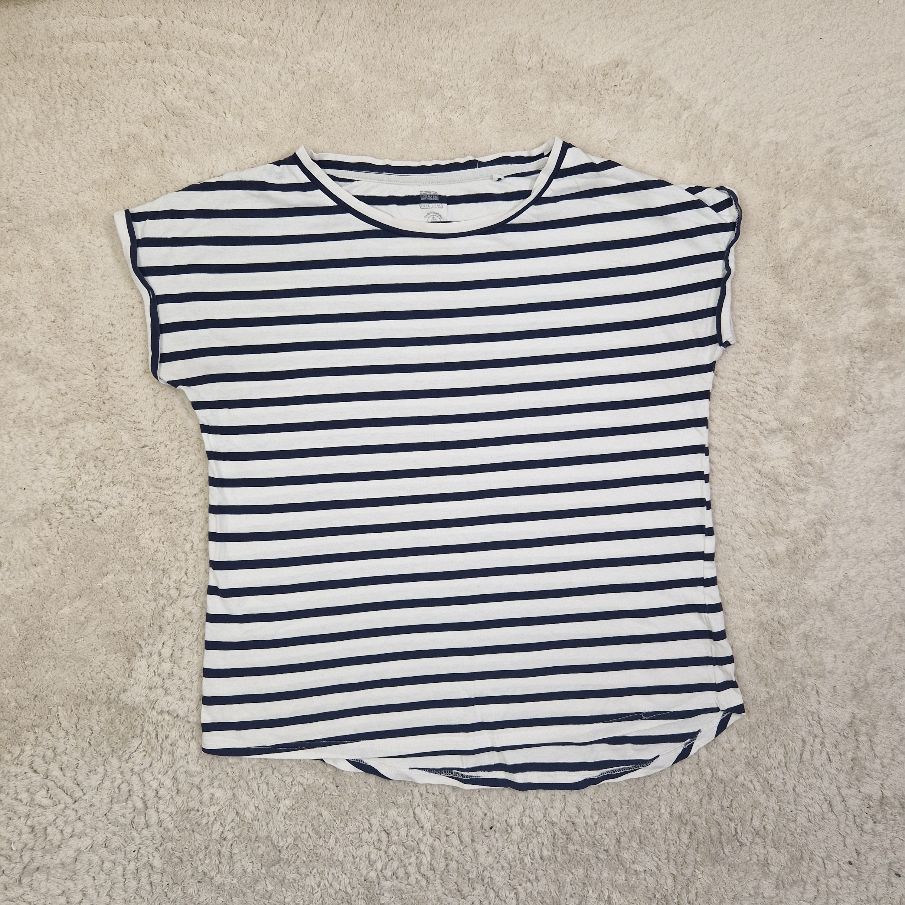 Striped shirt on a beige carpet