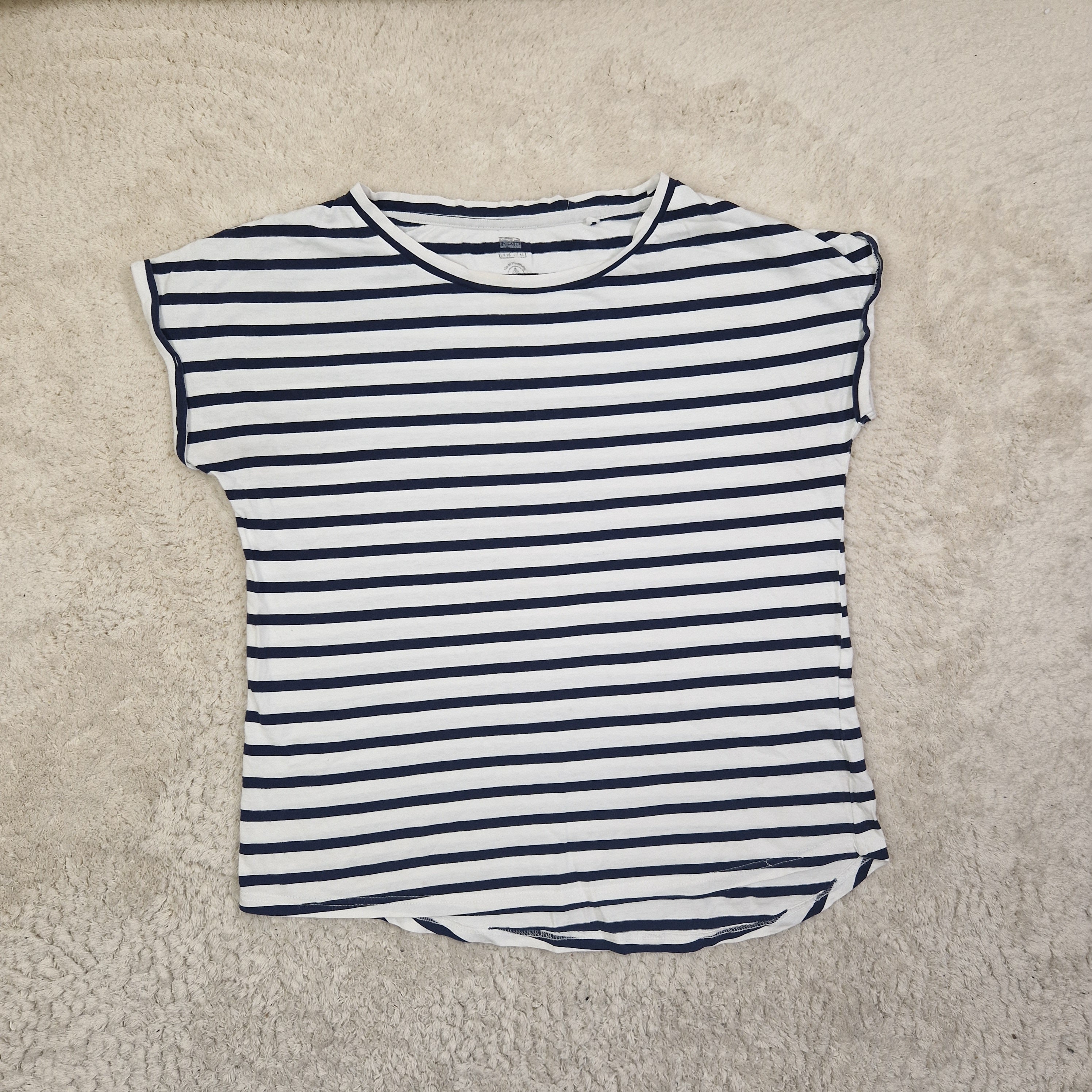 Navy and white striped shirt on a beige carpet