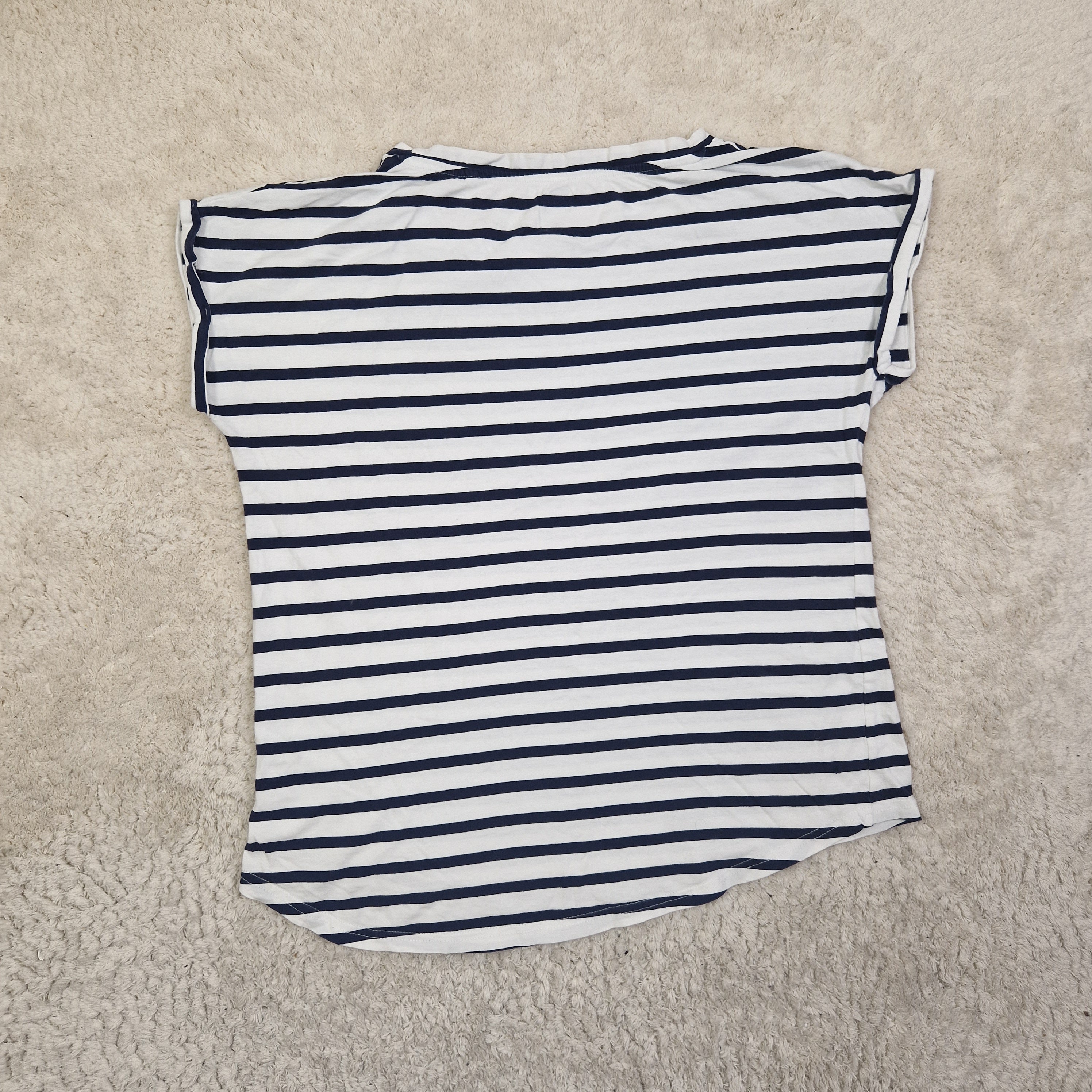 Striped shirt on a beige carpet