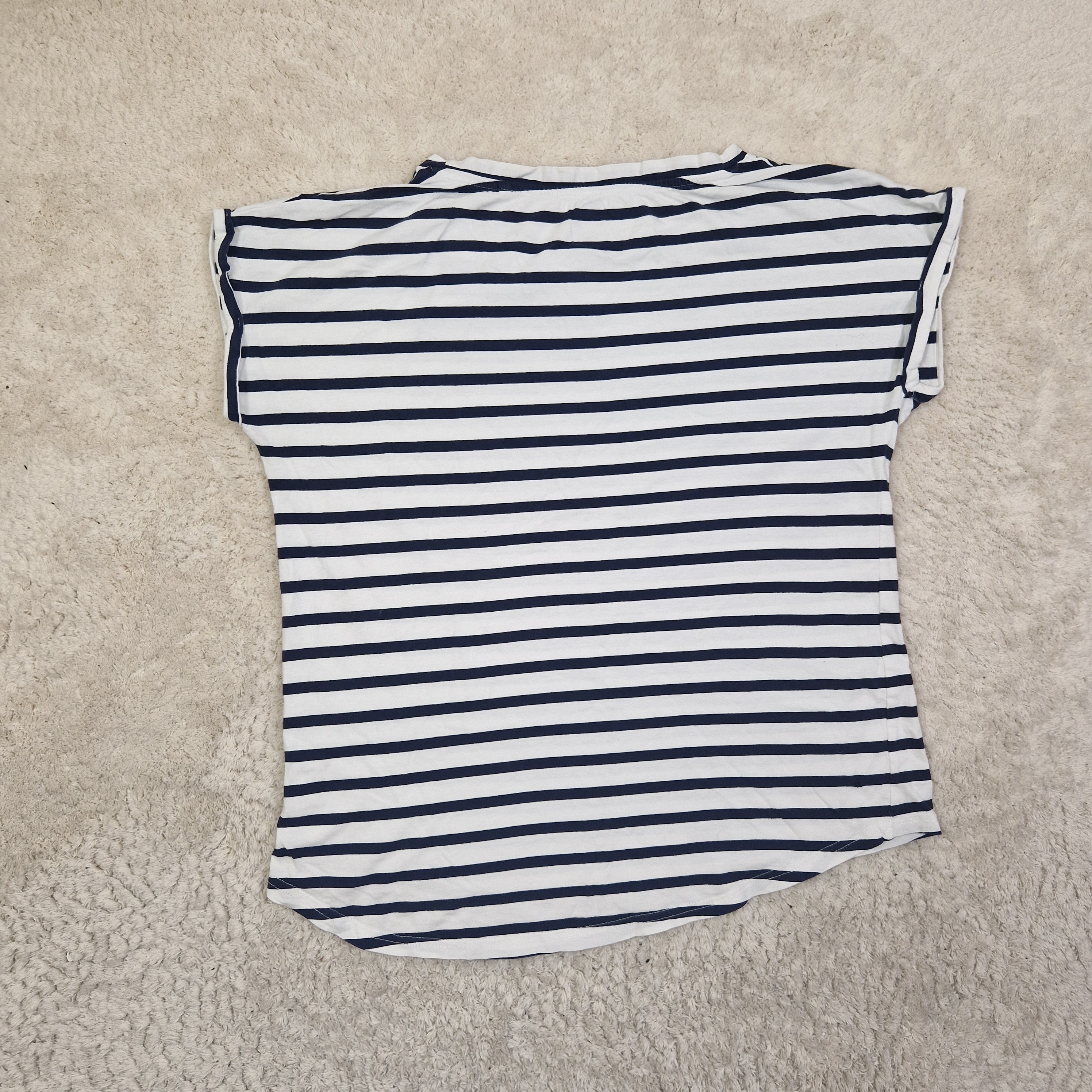 Black and white striped shirt on a beige carpet